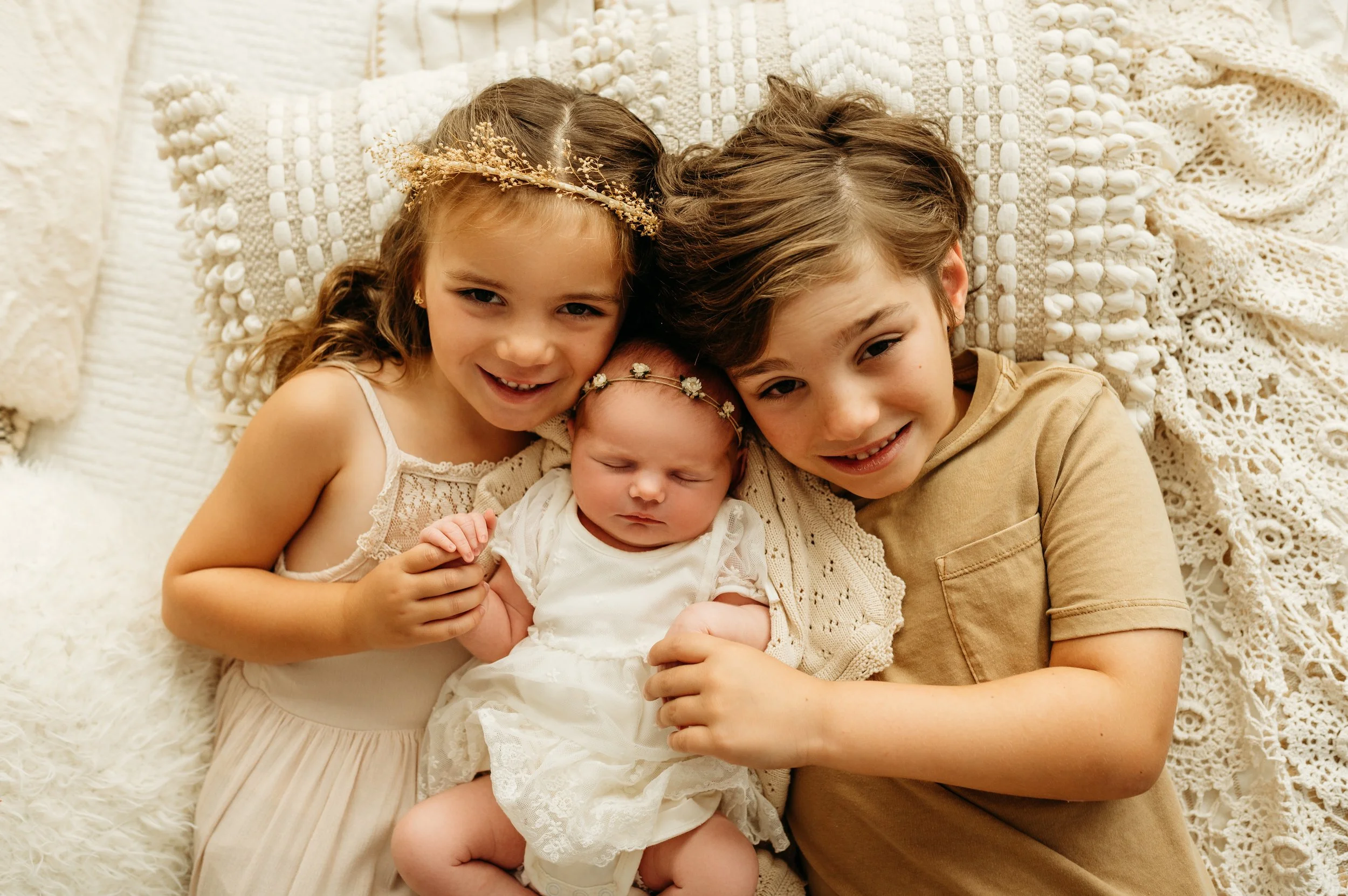 smiling photo with brother and sister holding their newborn baby sister in Pleasant View, TN