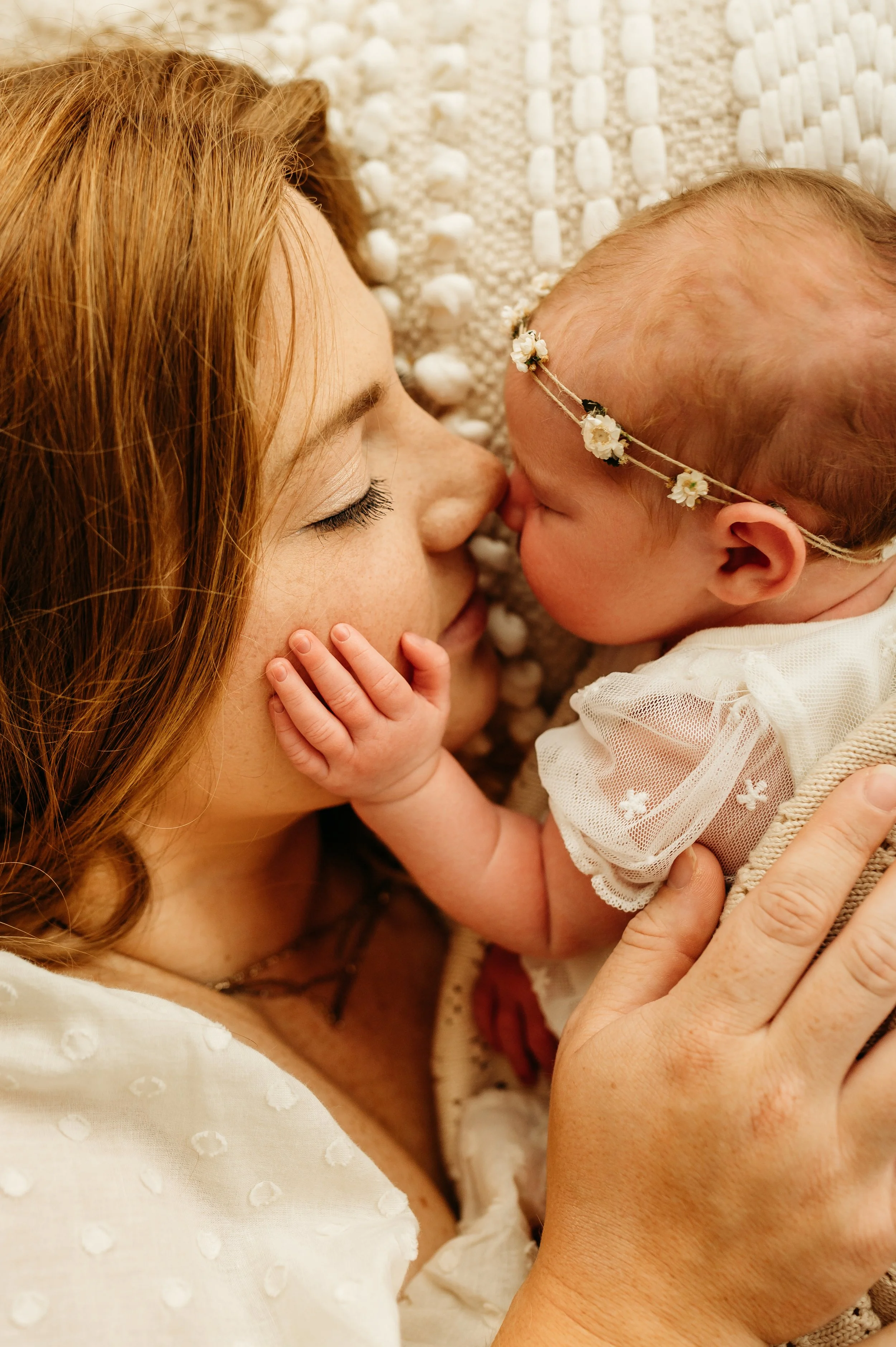 precious detail photos of newborn baby girl's hand on moms cheek in Nashville, TN