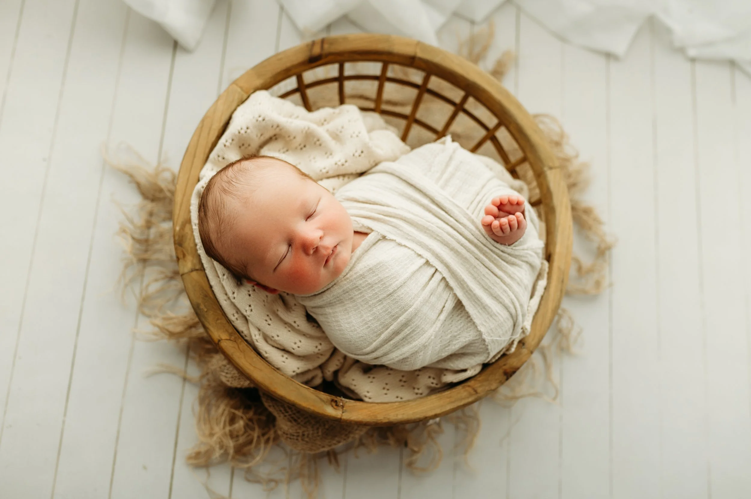 nashville tennessee baby boy swaddled and cozy in a white wrap for his newborn session