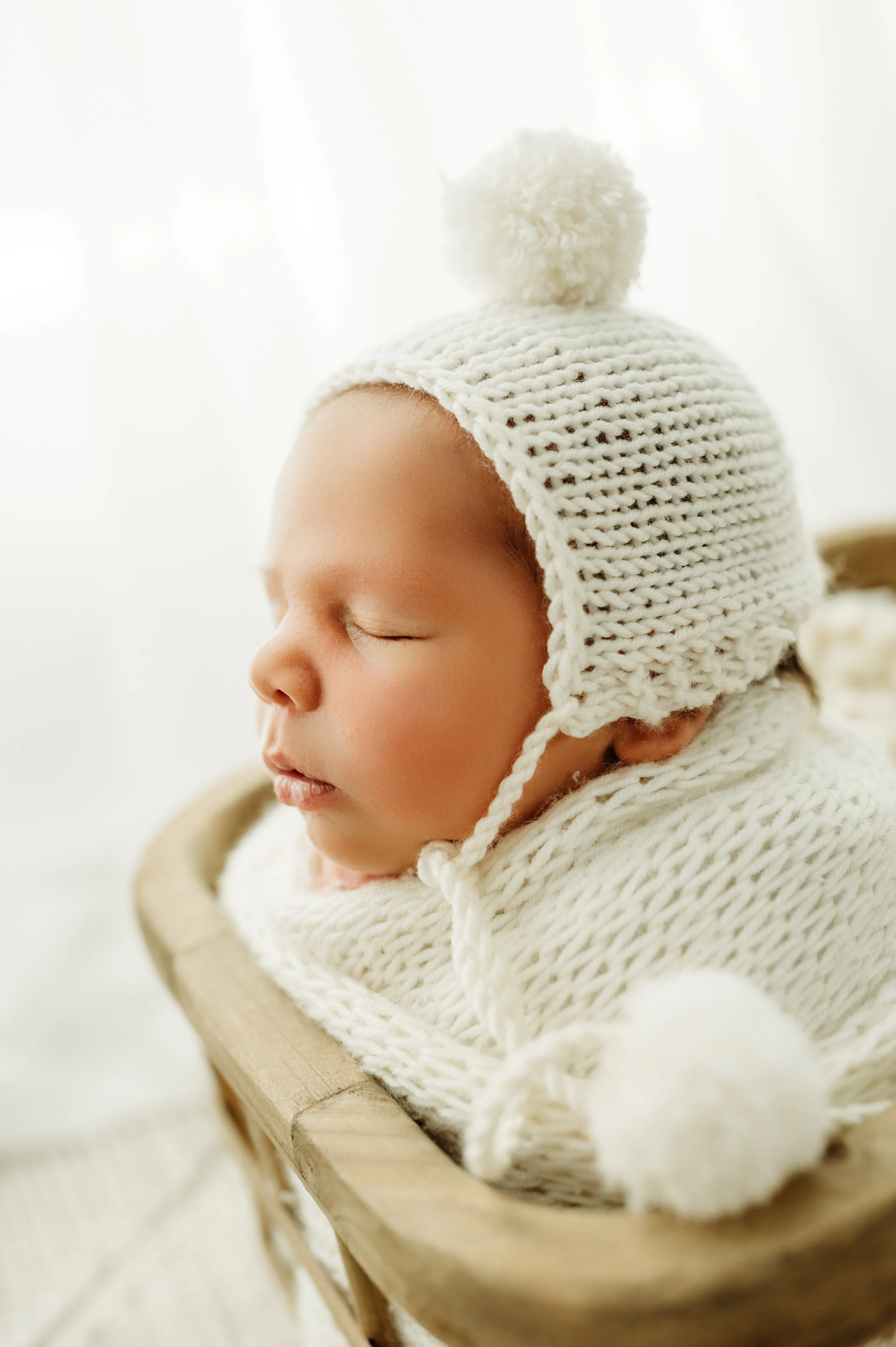 newborn baby boy with a bonnet in a clarksville, tn photography studio