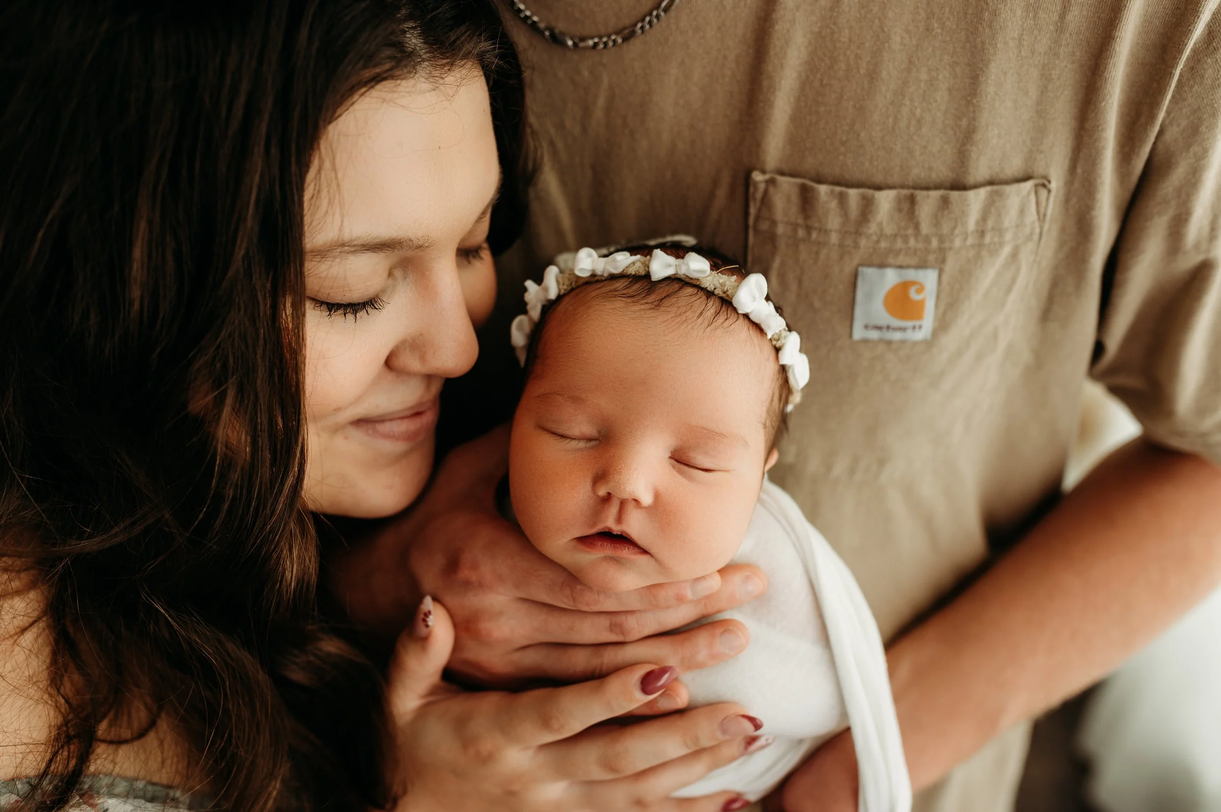 mom admiring her newborn baby girl in a clarksville, tn newborn photography studio