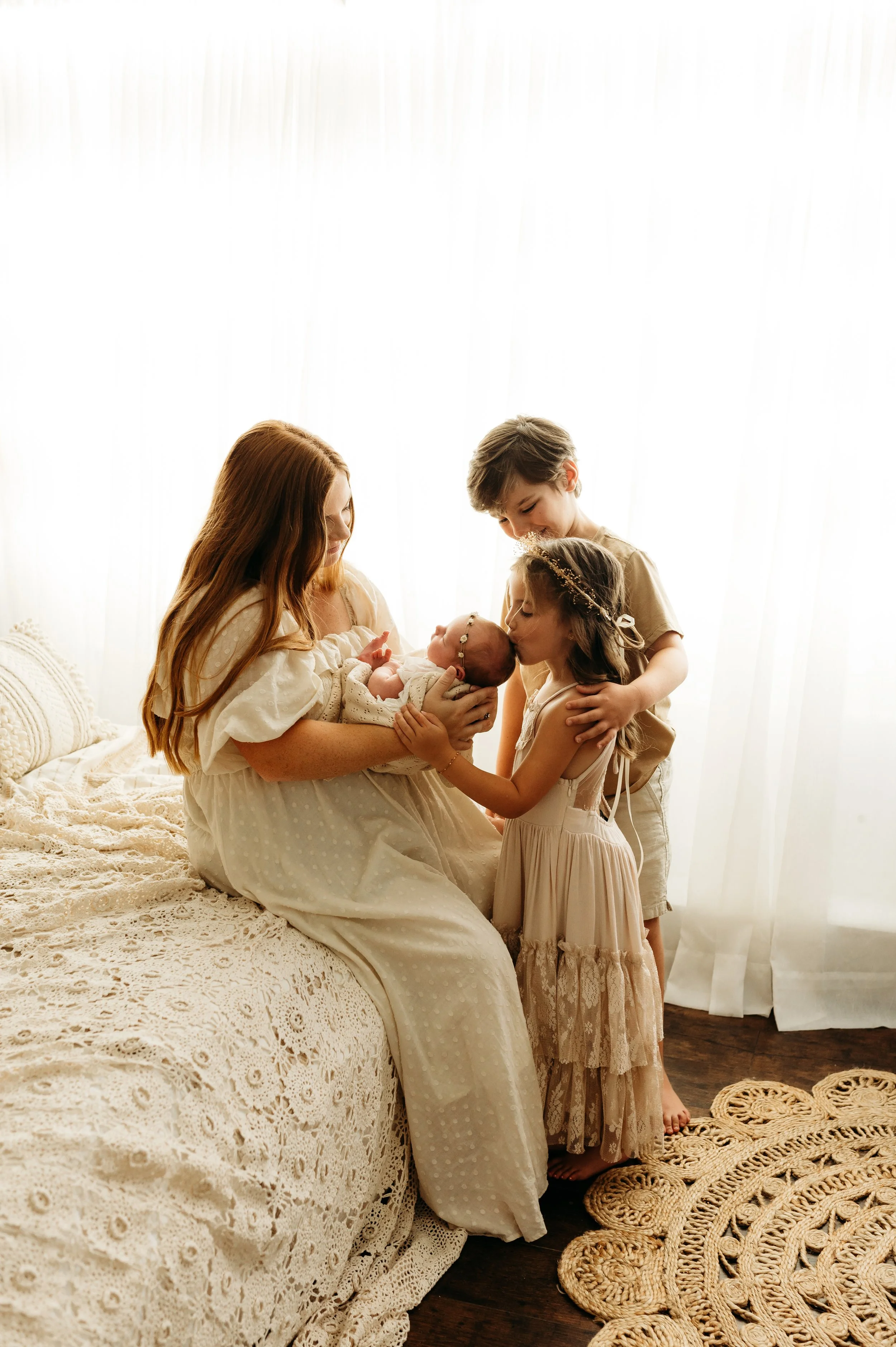 Mom and children snuggling a newborn baby girl in Nashville, TN 