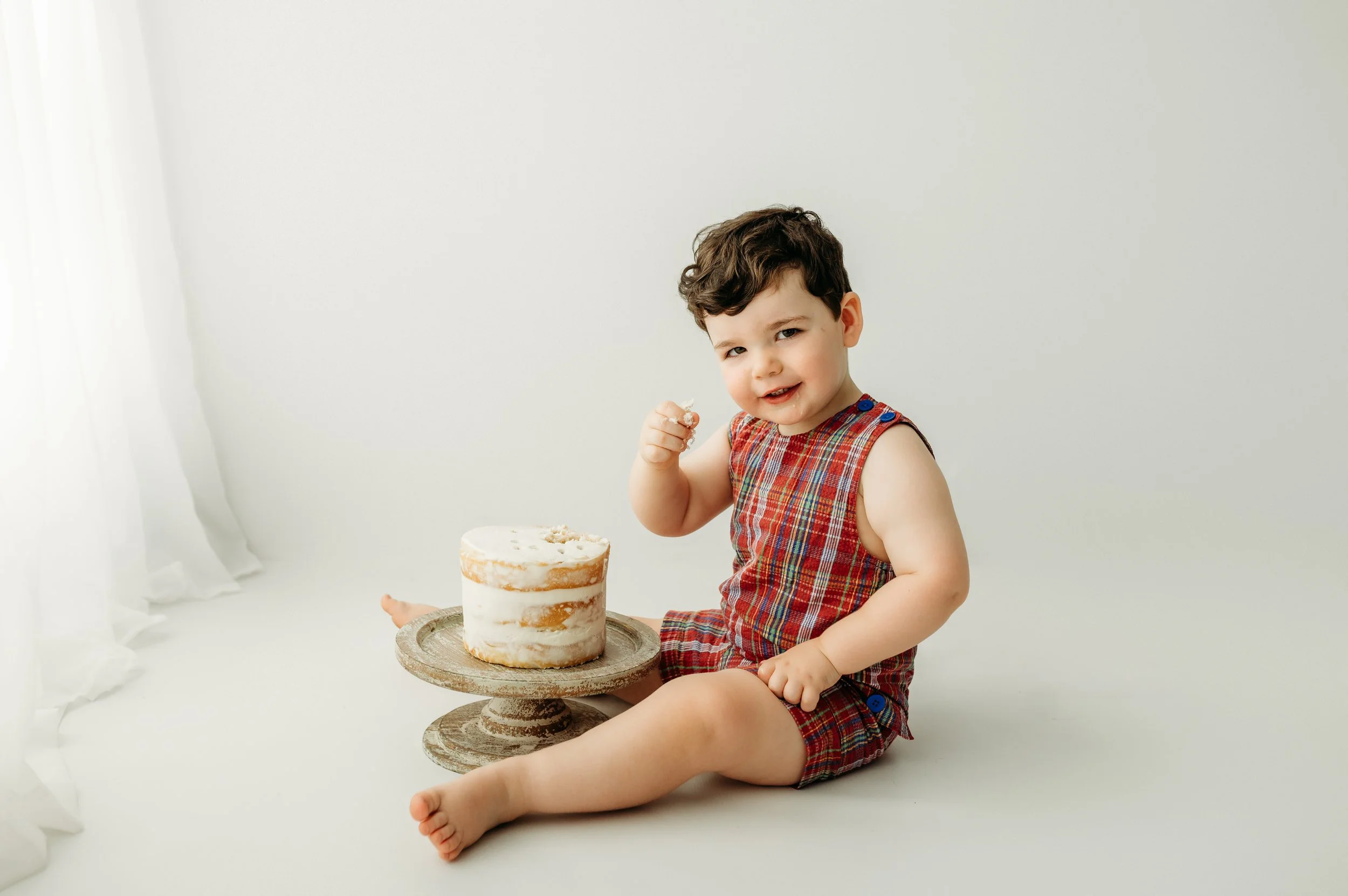nashville, tn baby boy cake smash session taken place in a beautiful all white studio