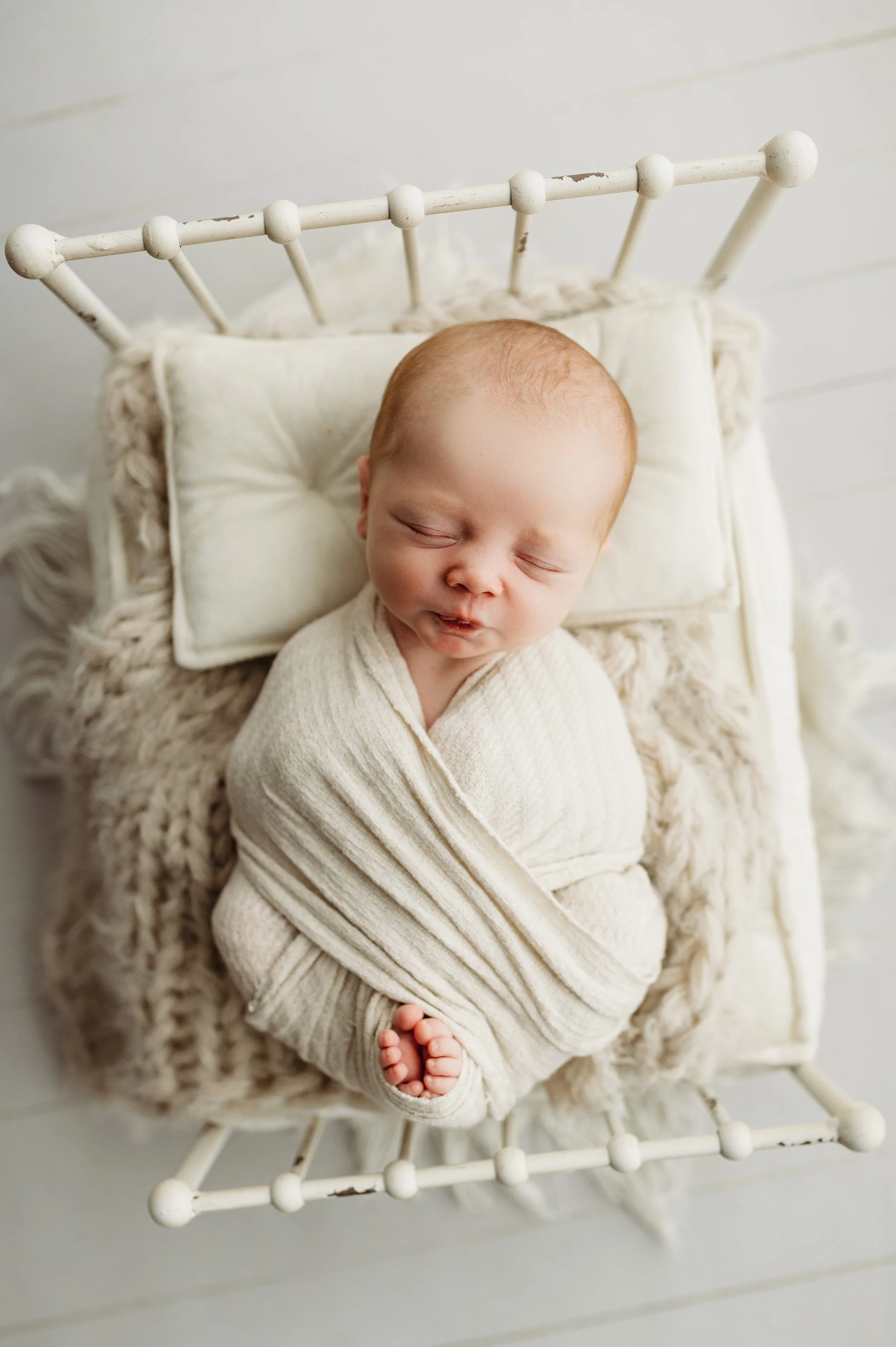 newborn baby boy swaddled in white session in Pleasant View, TN near Nashville, TN