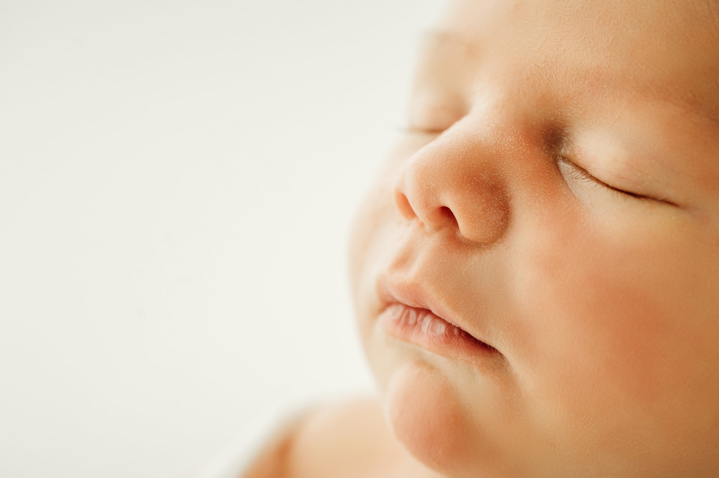 newborn baby boy on a timeless white backdrop profile detail shot by a Nashville, TN photographer