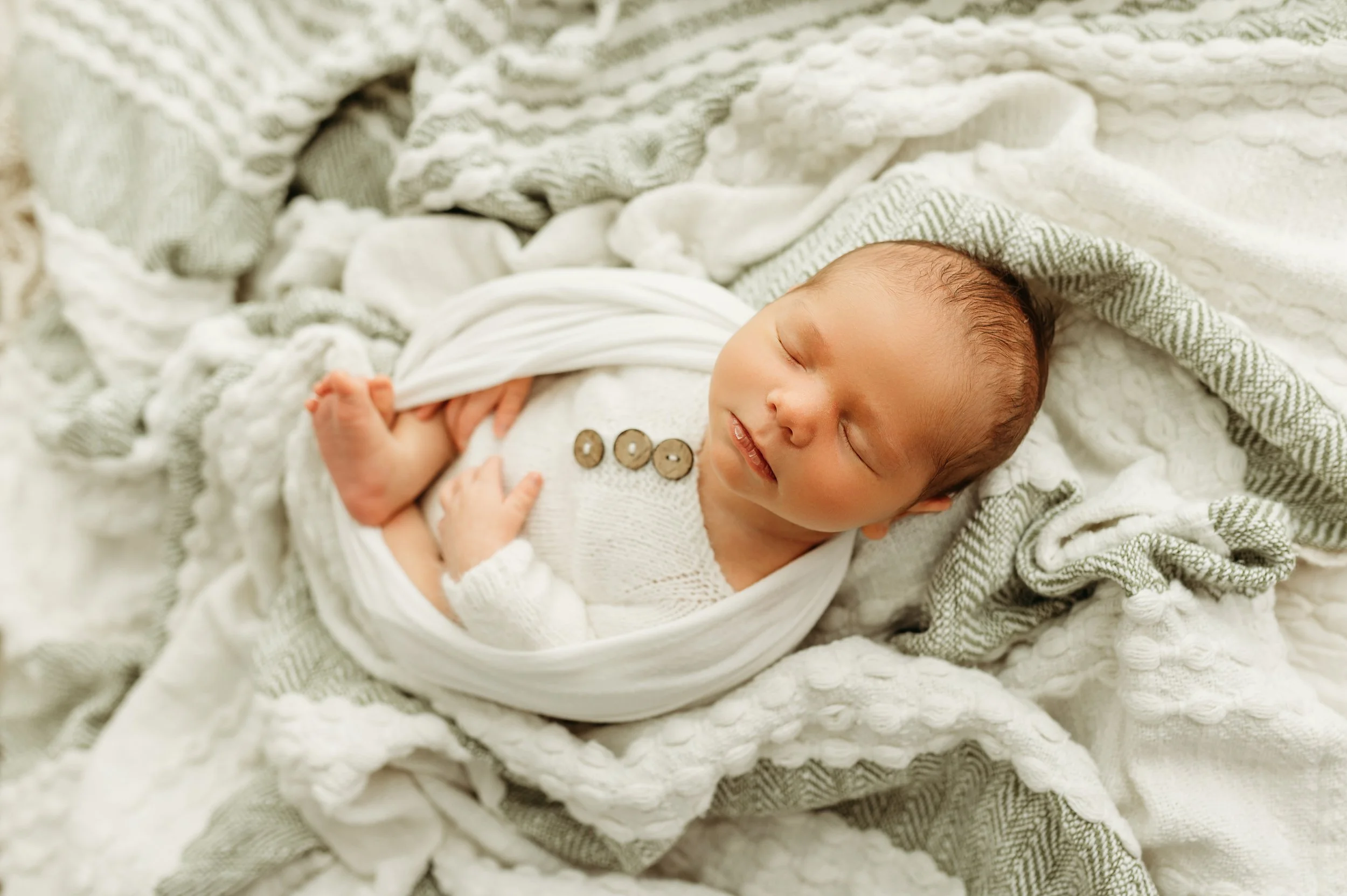 newborn baby boy on a blanket for his newborn photos done by a nashville, tn newborn photographer