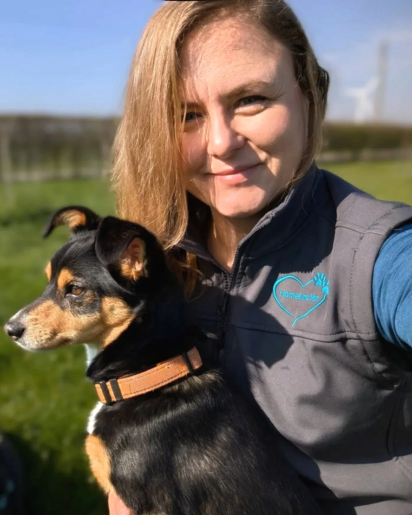 Veterinary surgeon providing calm, at-home euthanasia for a dog in a peaceful outdoor setting.