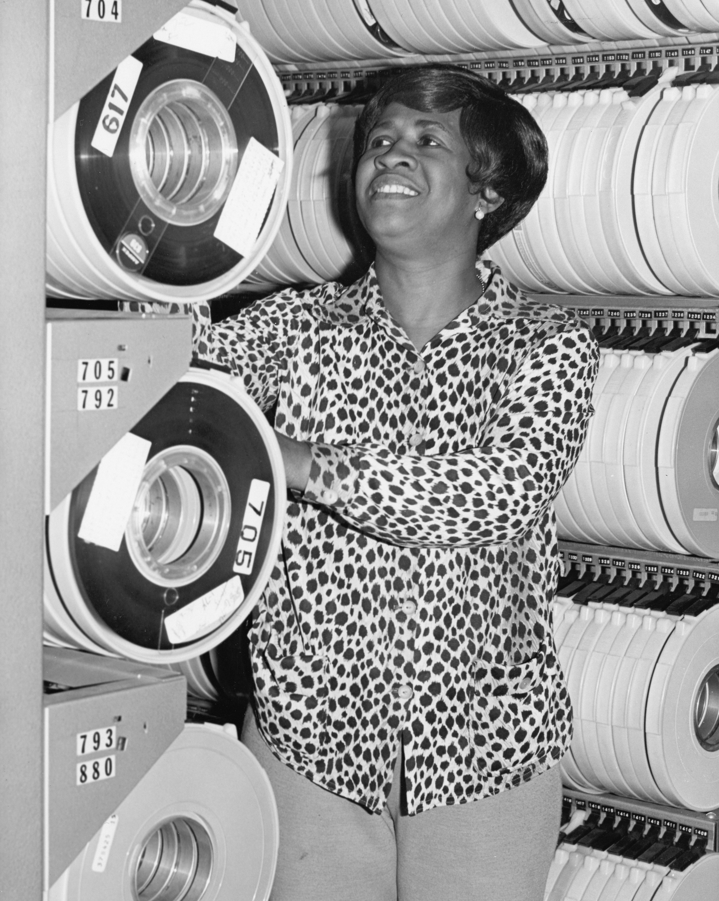 Historic photo of woman working with rolls of data