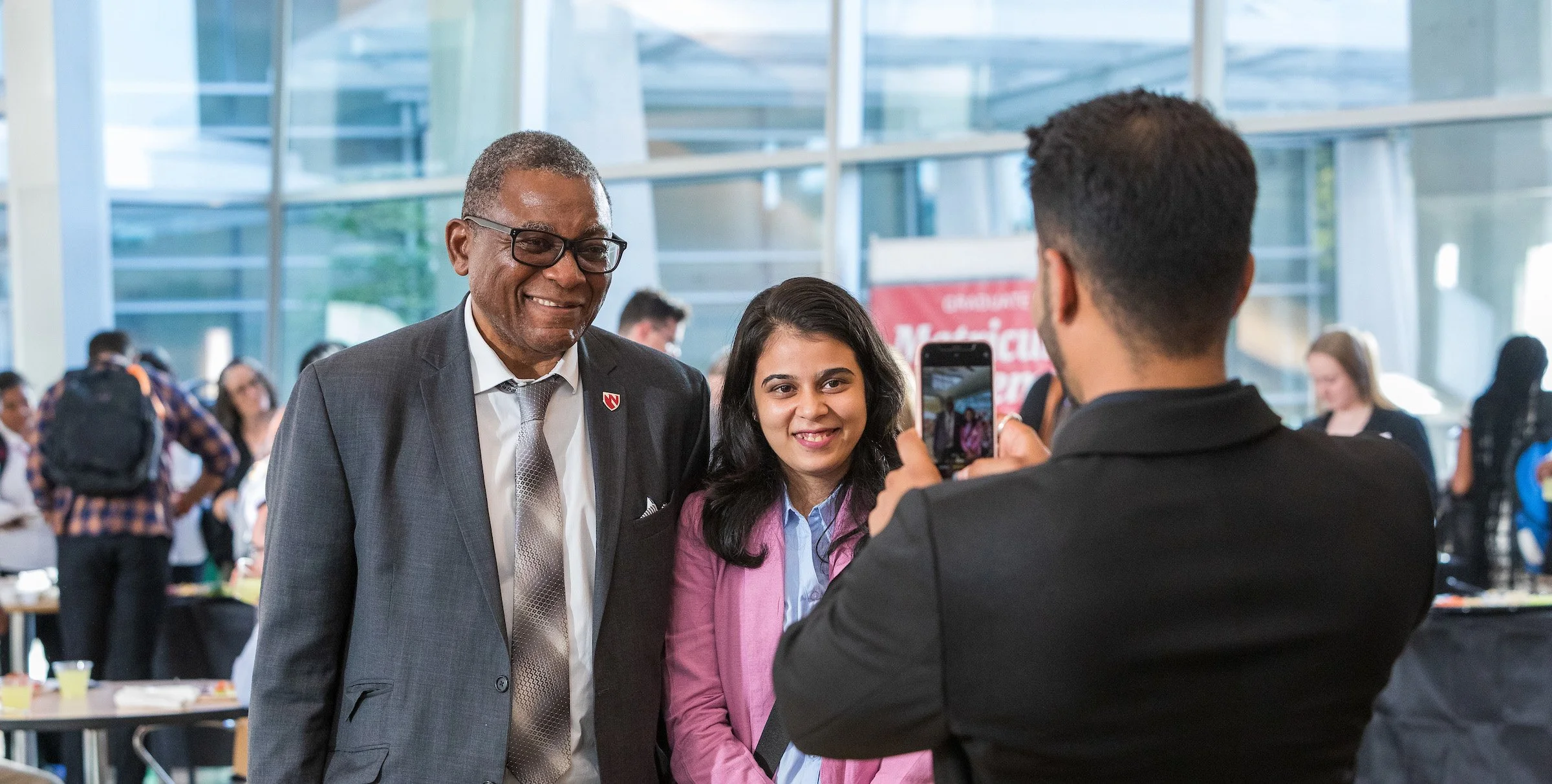 Dr. Dele Davies poses with student at matriculation ceremony