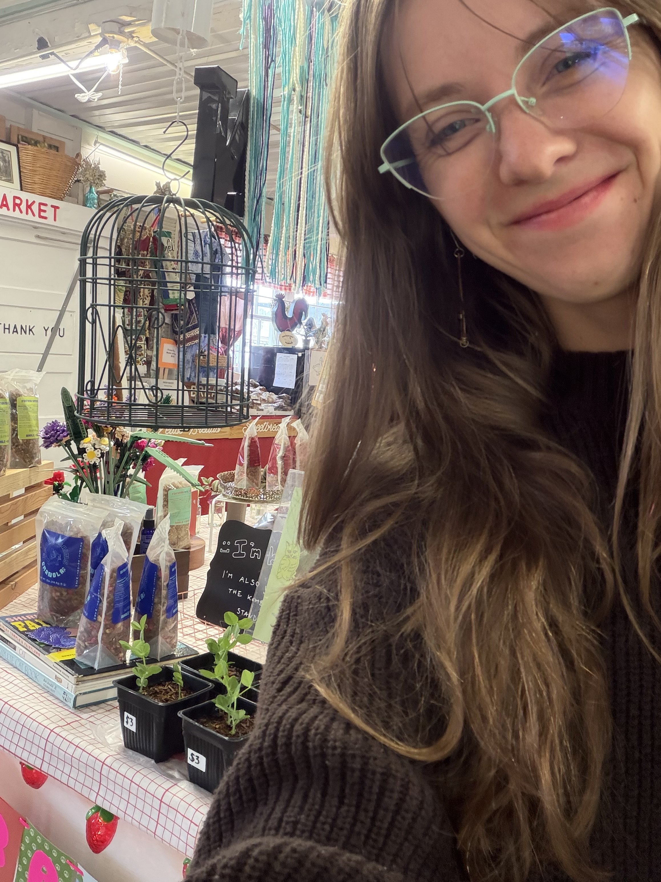The owner of Feral Grains Granola Co. at one of her markets selling granola.