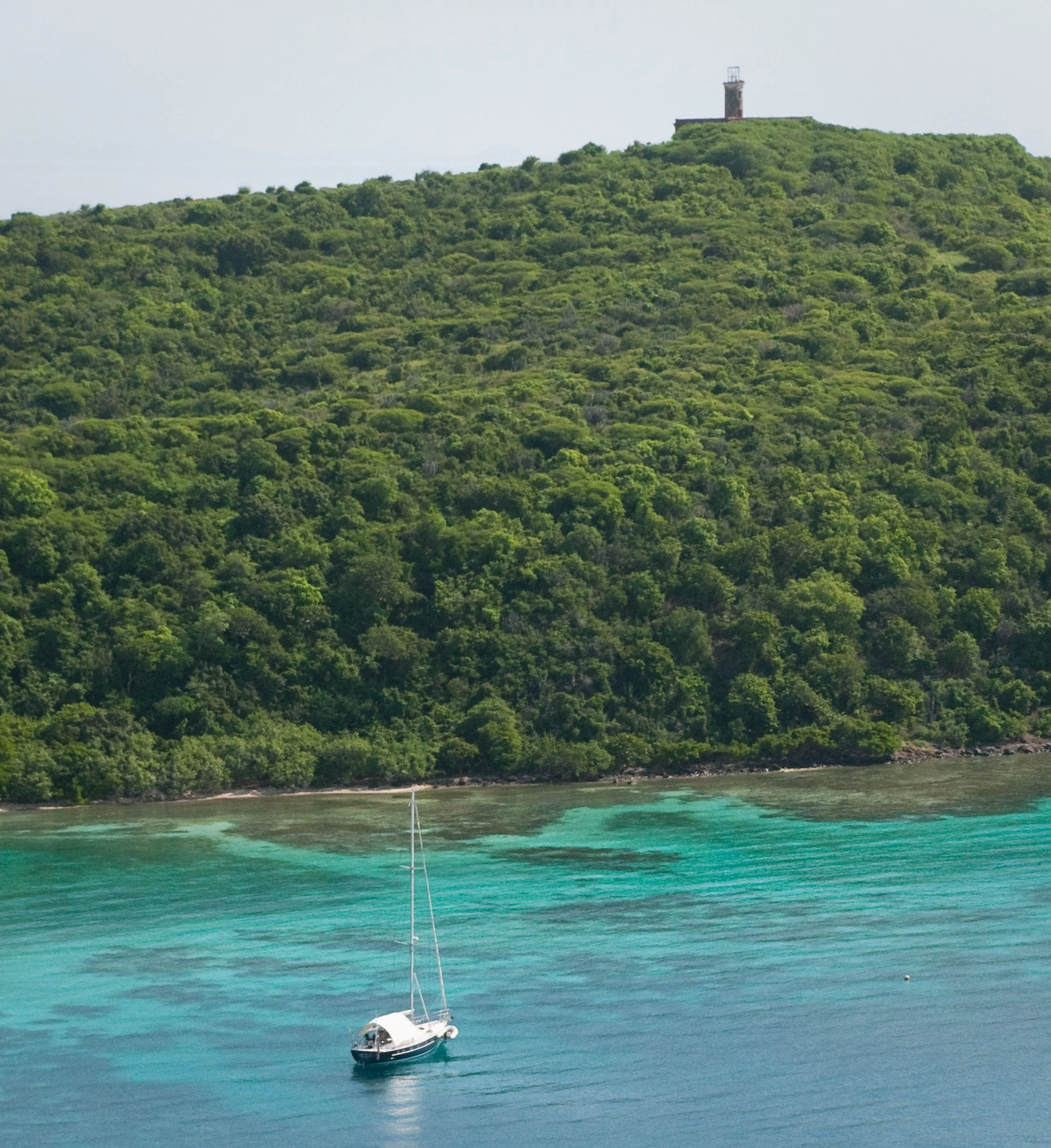 Sailboat moored behind Culebrita Lighthouse