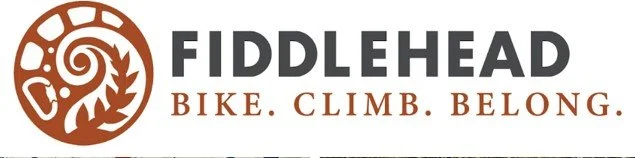 Fiddlehead logo with a spiral and leaf design, and the text 'FIDDLEHEAD BIKE. CLIMB. BELONG.'