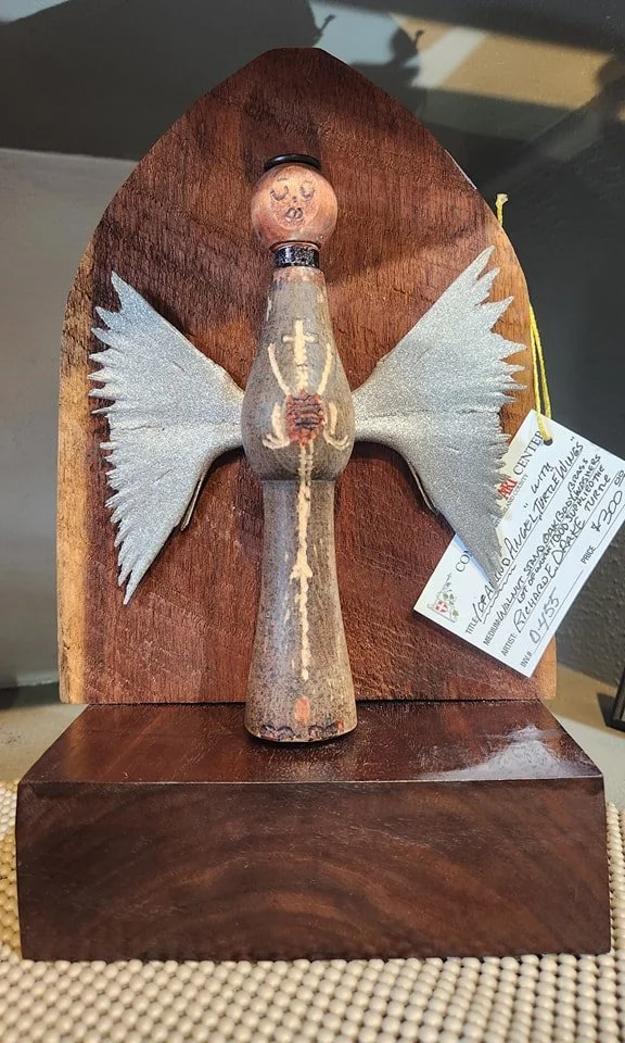 A wooden angel figurine with painted features created by artist Richard Drake,  located at the Community Art Center of Switzerland County in Vevay, Indiana