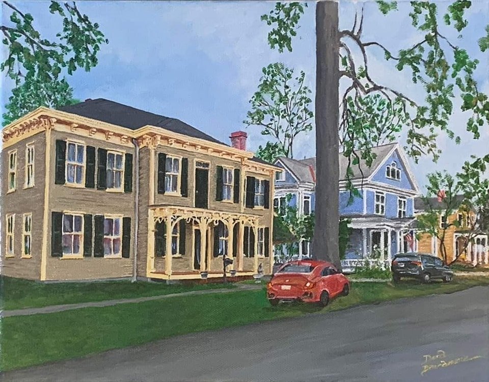 A painted illustration of a residential neighborhood with several colorful Victorian-style houses, large trees, a red car parked on the grass, and a paved street in the foreground.