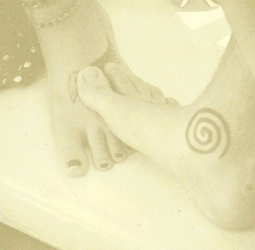 Photo of two people's feet touching each other, both feet have tattoos.
