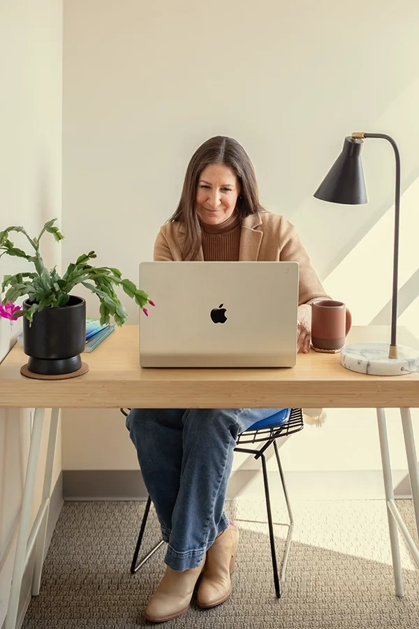 Therapist & coach Dana Marcus having an online therapy session with a client.