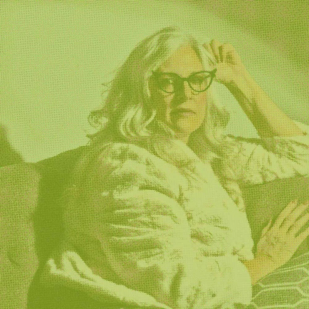 Bold-looking woman with long gray hair in a faux fur coat, represents how therapy for self-esteem & identity in Philadelphia can help you find confidence.