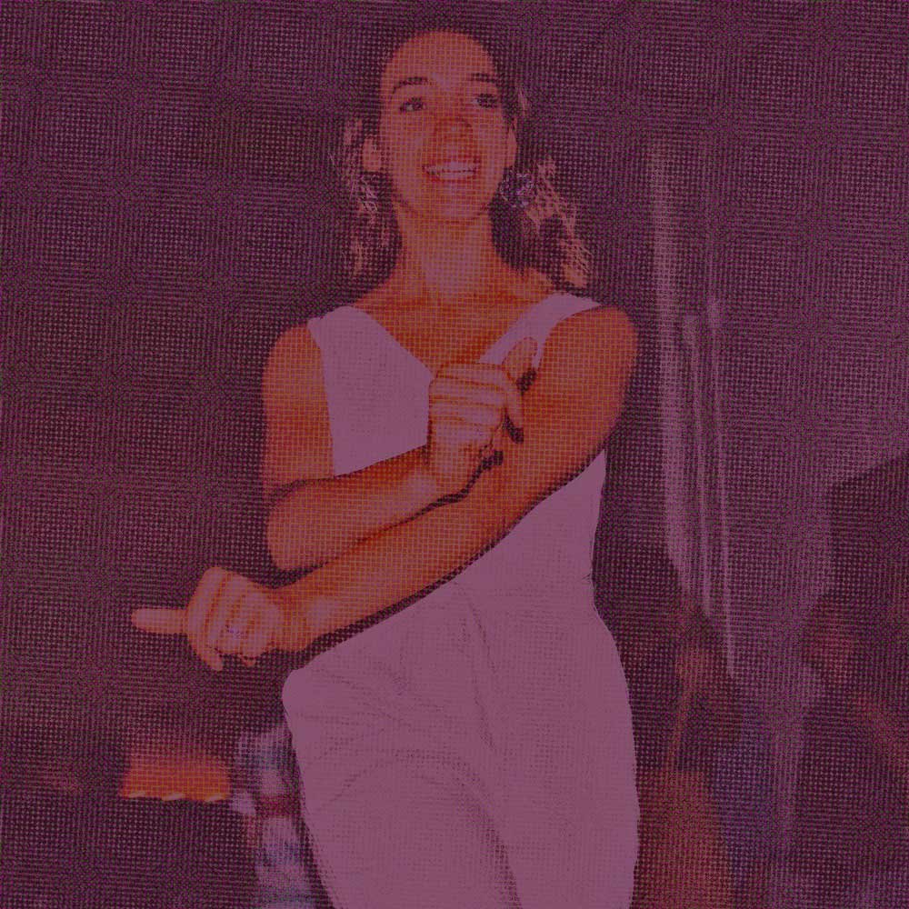 Woman in a white dress, smiling & dancing; represents how other Green Fig services like DBT coaching can give you practical skills & build your confidence.