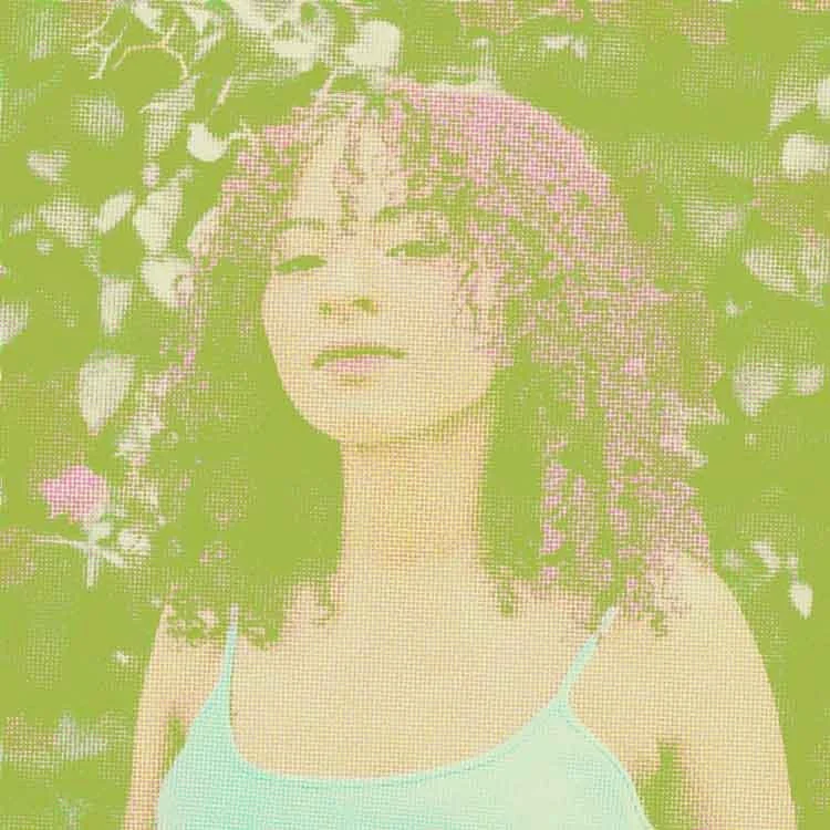 Woman with dyed-pink, naturally curly hair; represents how individual therapy in Philadelphia can help you feel more self-empowered.