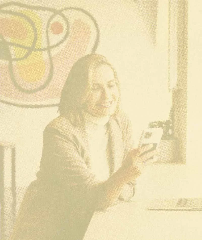 Smiling confident woman on a call at work, represents how ADHD support at Green Fig in Philadelphia can help you improve your self-esteem.