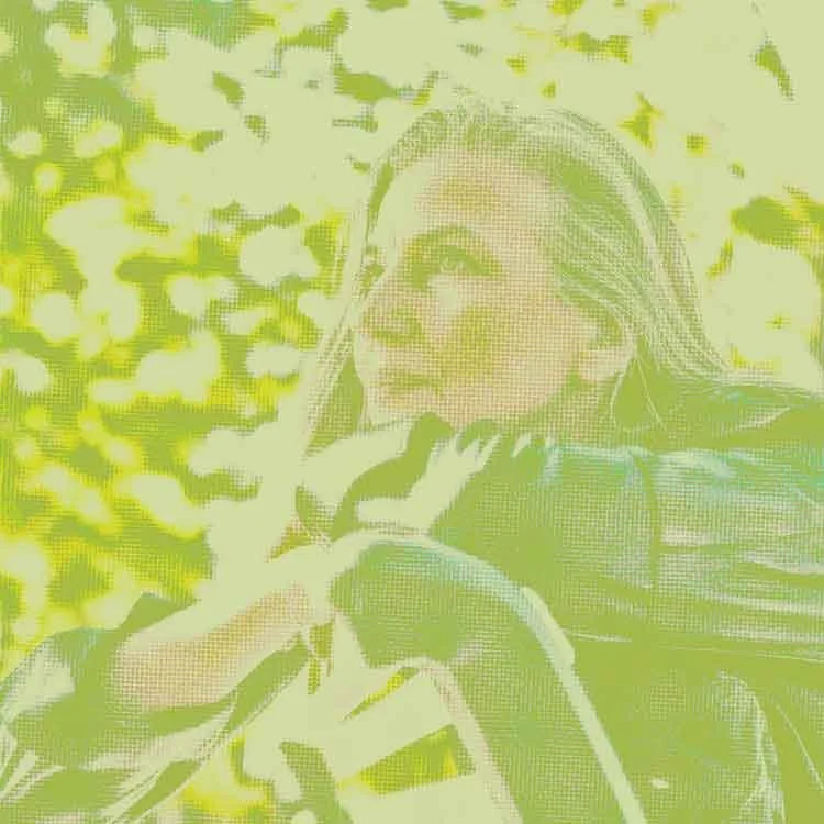 Mature woman with long gray hair outdoors, represents that you can (re)connect to your strength & resilience through therapy at Green Fig in Philadelphia.