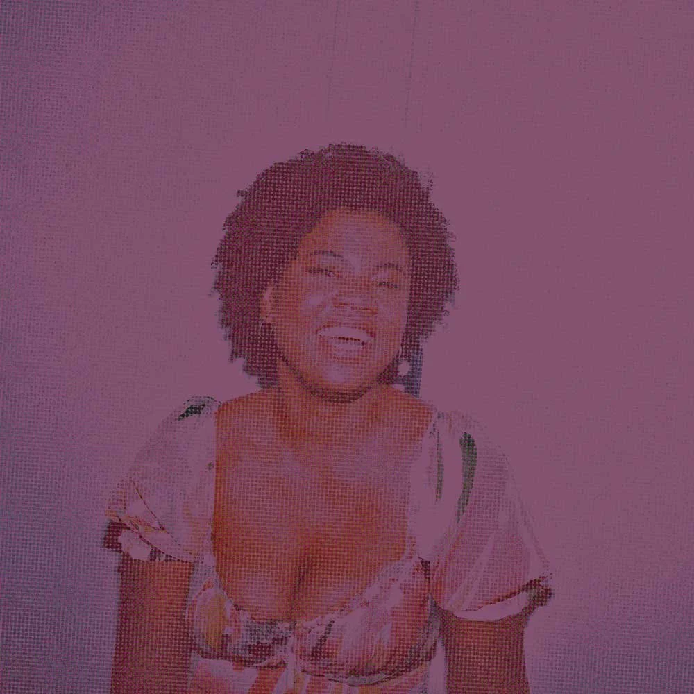 Black woman laughing joyfully, represents how working with a therapist on self-esteem & identity can help you feel more aligned & authentic.
