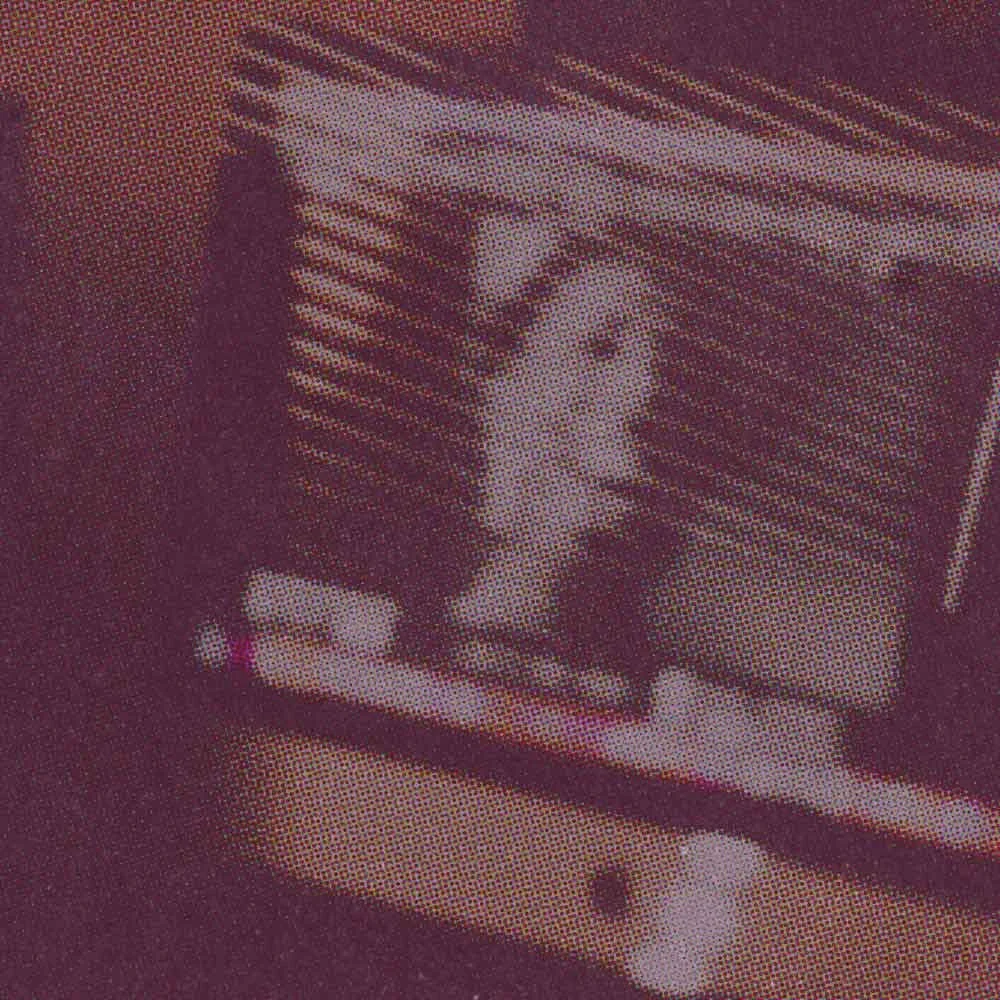A pixelated image of a woman on a computer screen, talking to her therapist in an online therapy session.