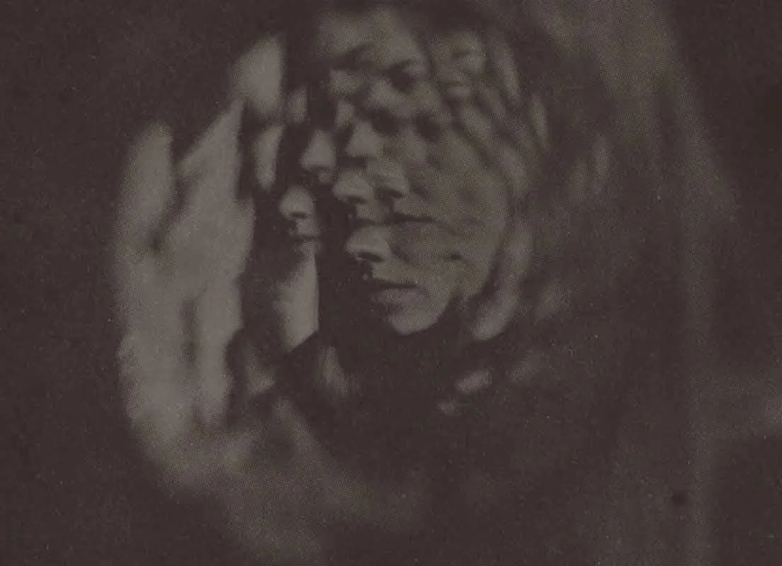 Sepia-toned photo of a woman, shown with multiple images of her face overlayed in a kaleidoscope effect.