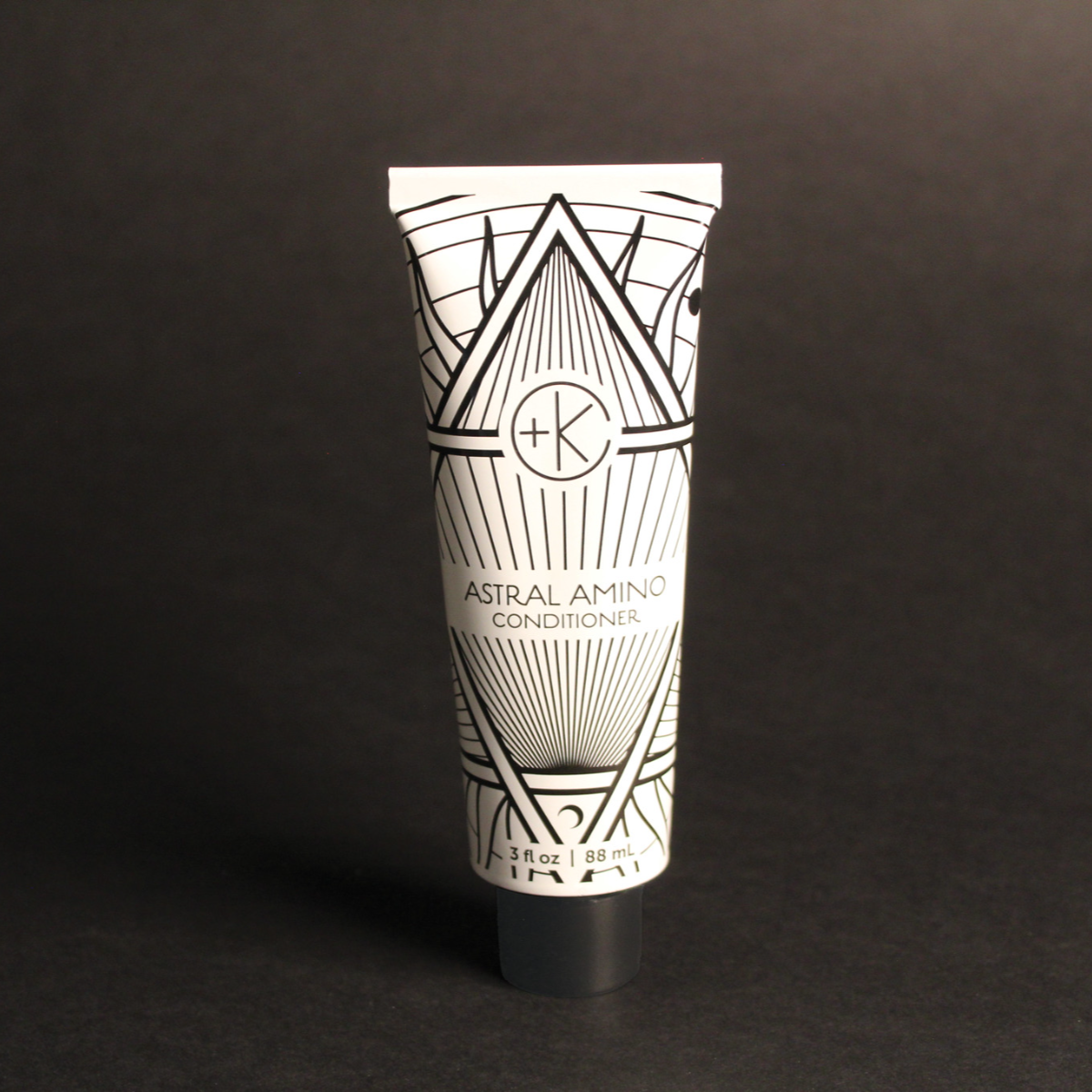 Image of a white and black tube of conditioner.