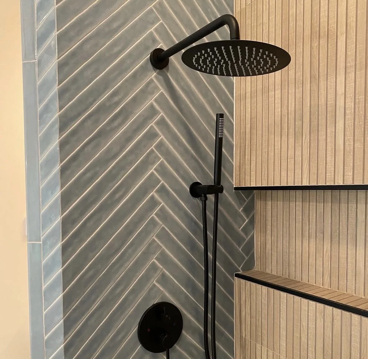 Master bathroom update-Walk-in Shower.
New walk-in shower featuring wood-look tile, herringbone detail, custom glass enclosure, and sleek black fixtures. 