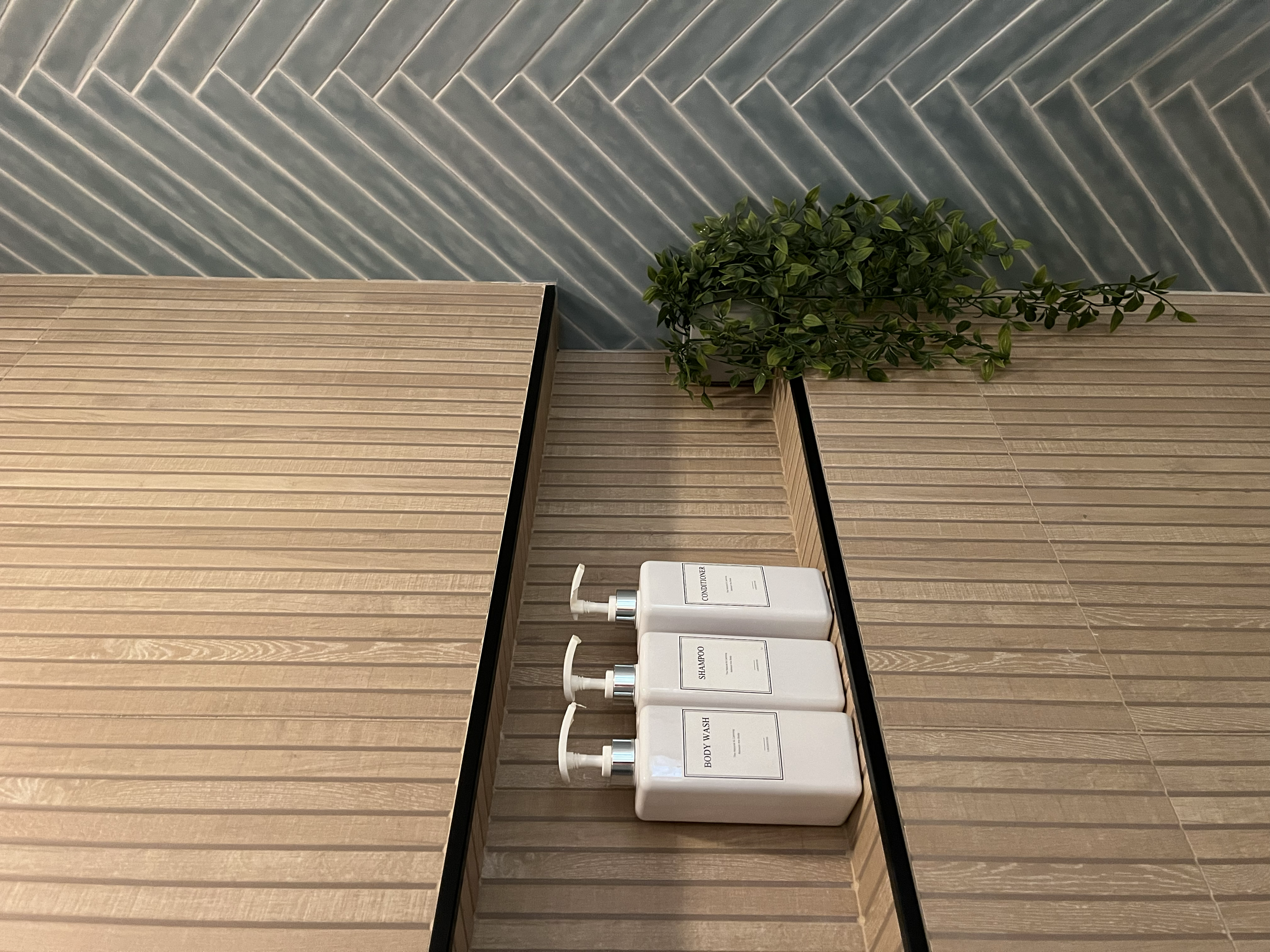Master bathroom update-Walk-in Shower.
New walk-in shower featuring wood-look tile, herringbone detail, custom glass enclosure, and sleek black fixtures. 