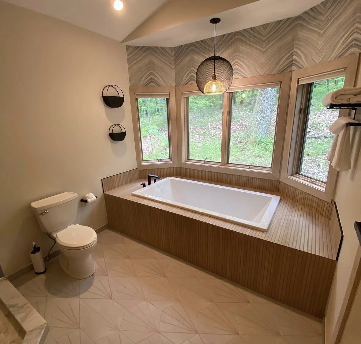 Master bathroom update-Walk-in Shower.
New walk-in shower featuring wood-look tile, herringbone detail, custom glass enclosure, and sleek black fixtures. 