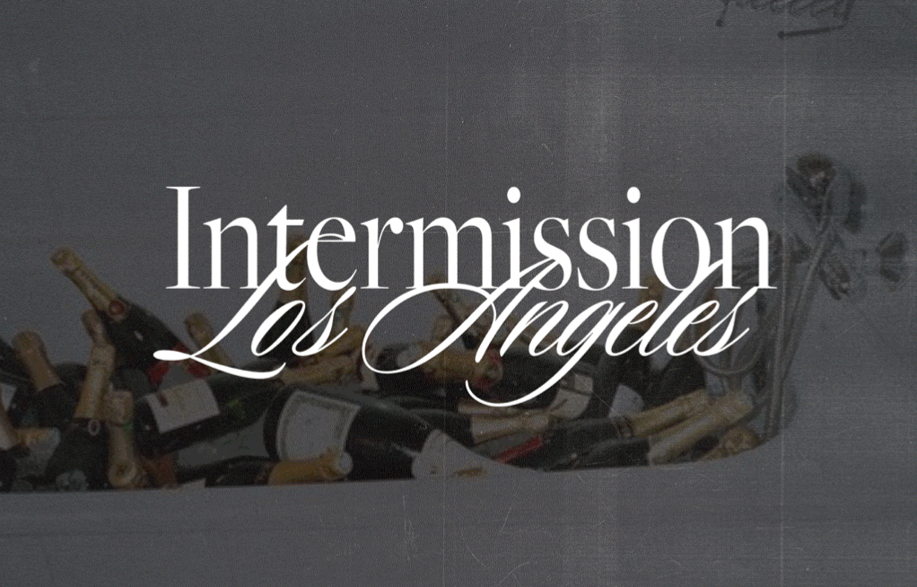 A box filled with empty champagne bottles and the overlay text "Intermission Los Angeles."