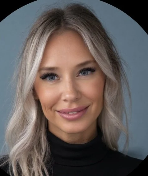 A woman with blonde, wavy hair and blue eyes smiling at the camera, wearing a black top against a blue background.