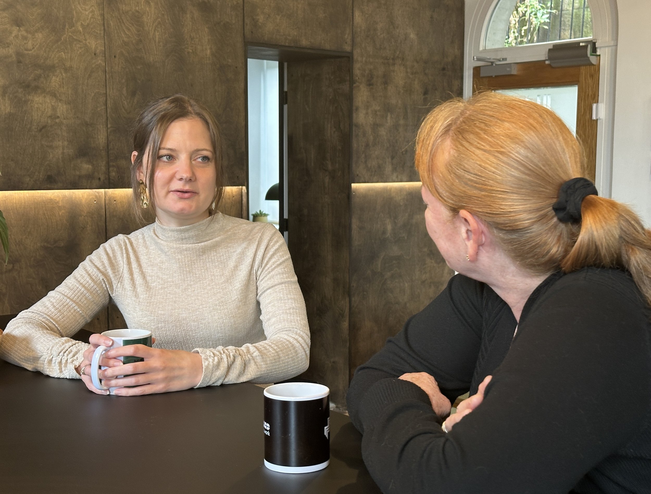 Professional woman and Jac in discussion indoors