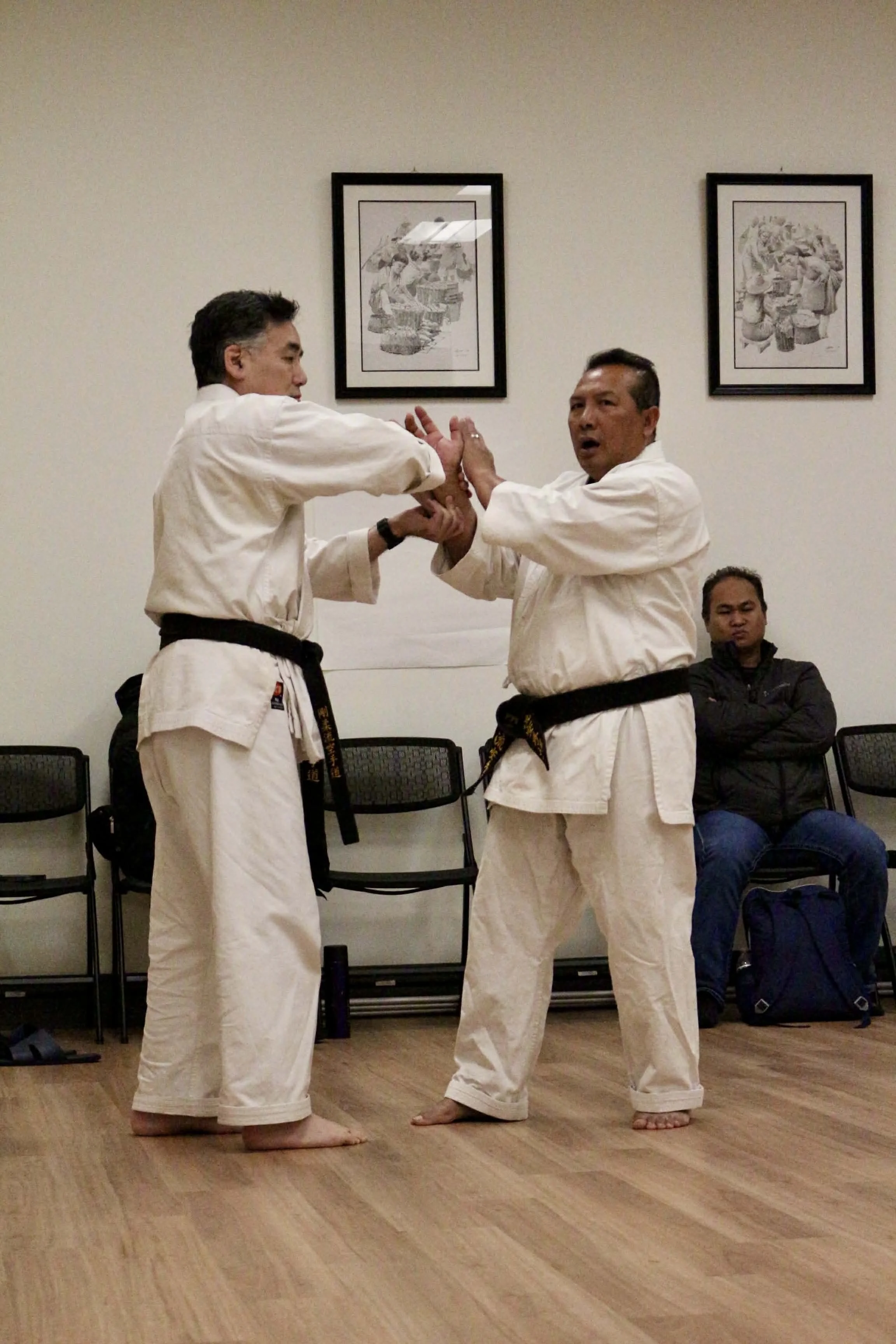 Kyo-Shi Danh demonstrating a join lock self-defense technique on Sensei Peter