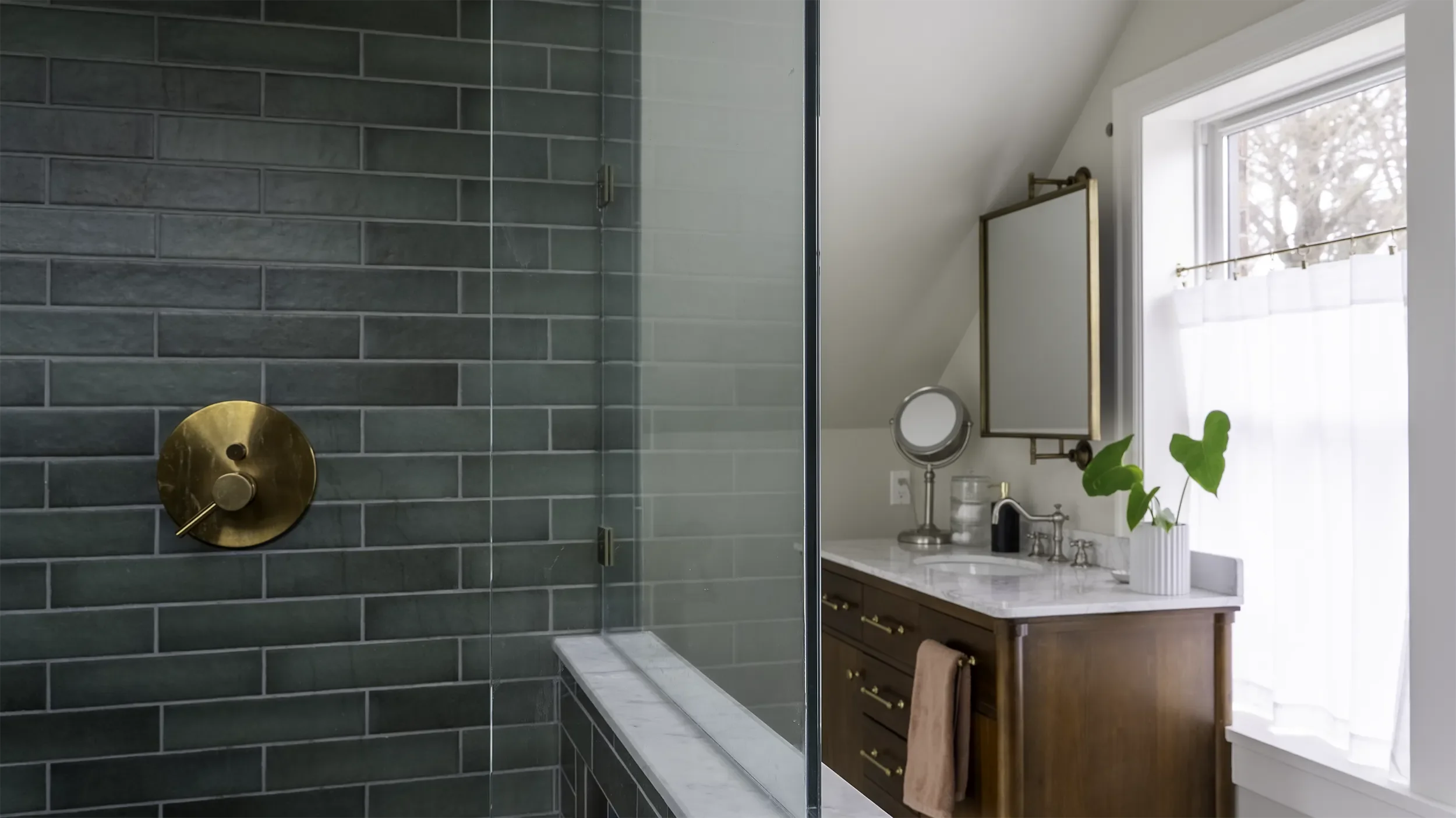master bath remodel in Seattle with green tile shower surround, brass hardware and marble tile