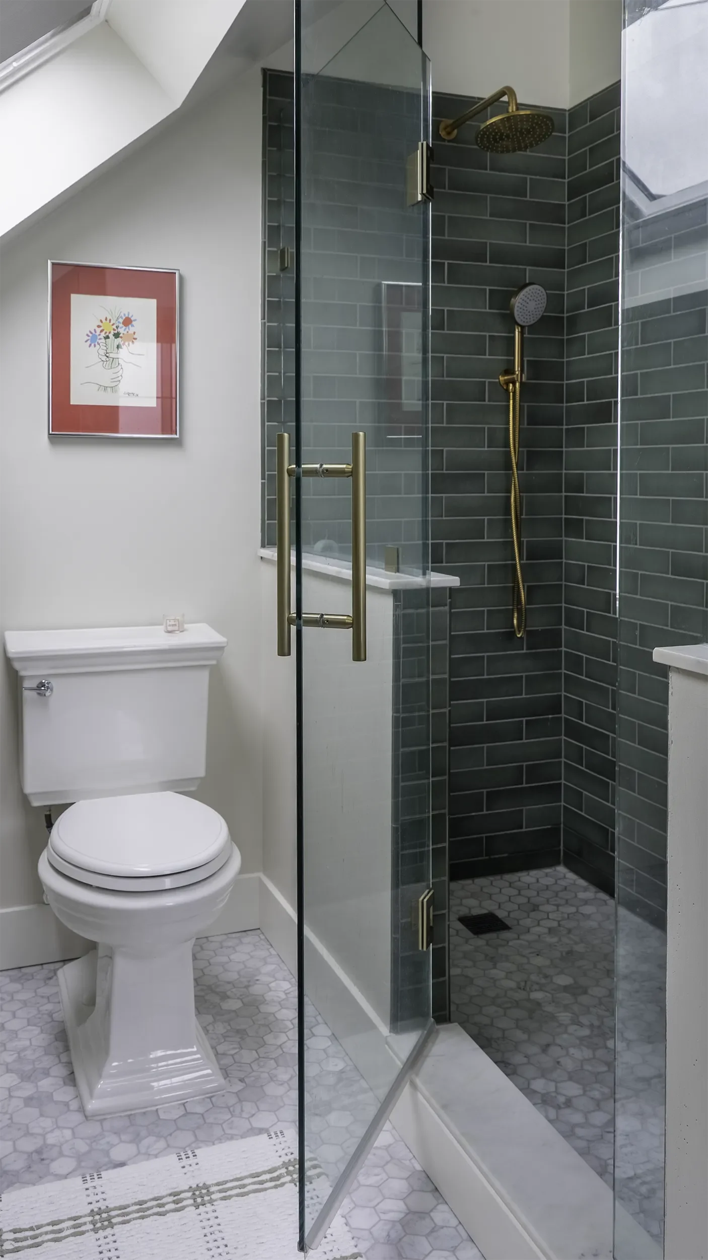 master bath walk-in shower with green tile, marble flooring, and brass fixtures
