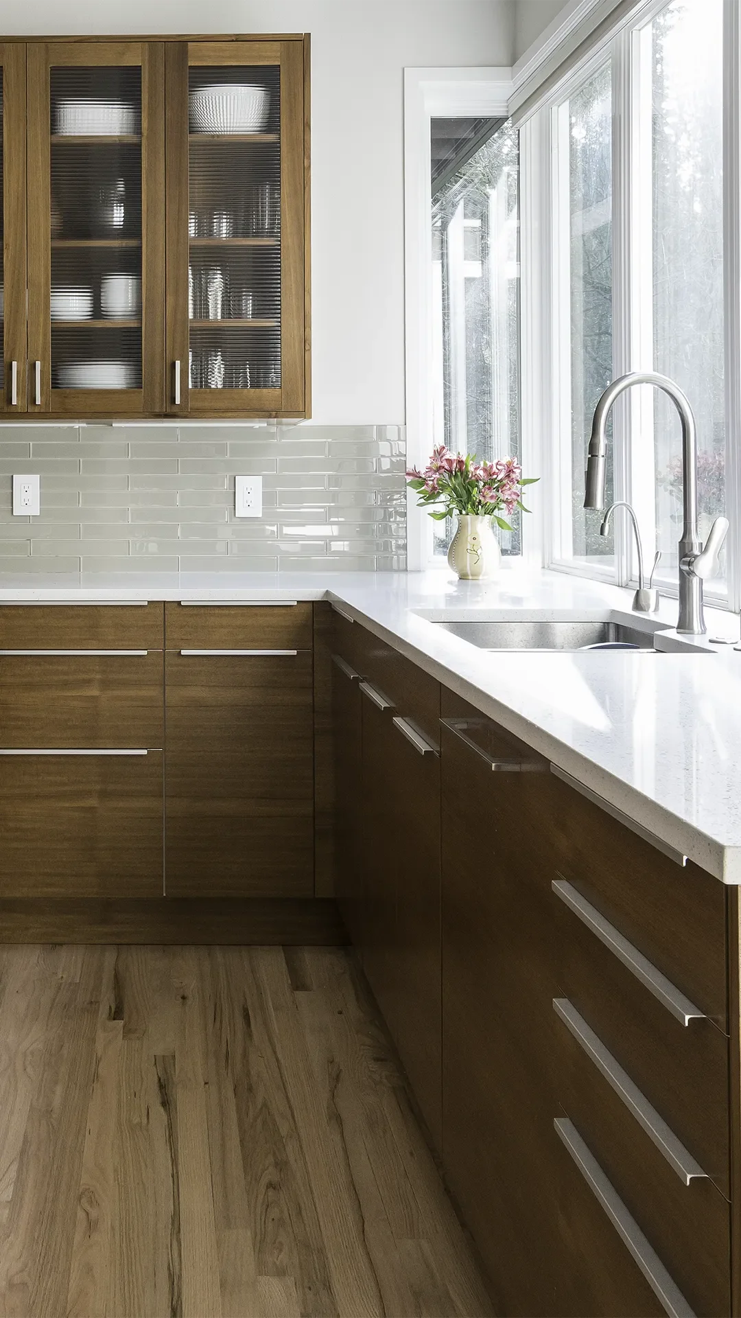 Sammamish IKEA Kitchen installation with custom teak doors and horizontal grain, featuring side by side integrated refrigerator and freezer, and island with raised bar.
