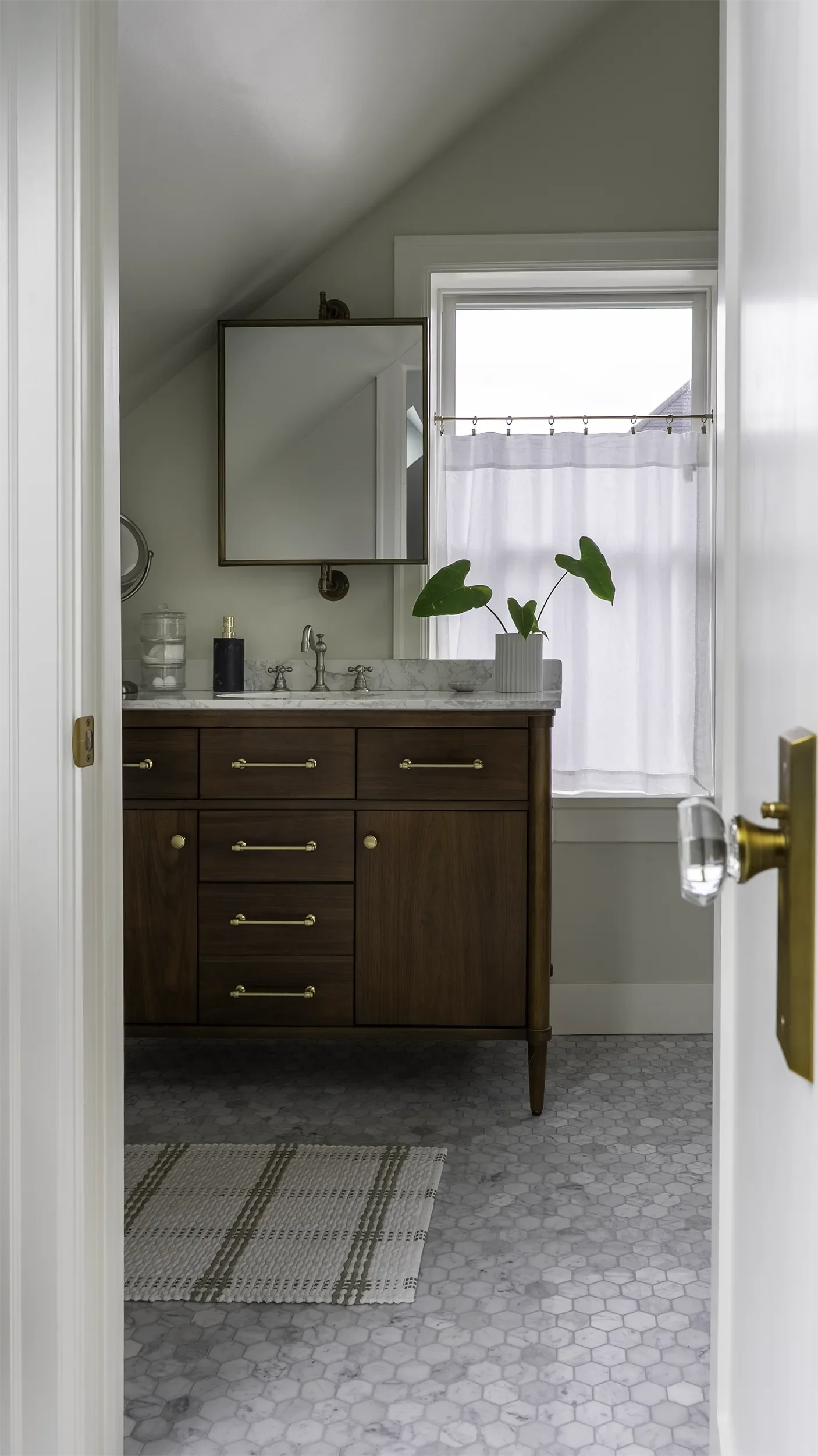 primary-bath-remodel-seattle-marble-tile-flooring-brass-fixtures.webp