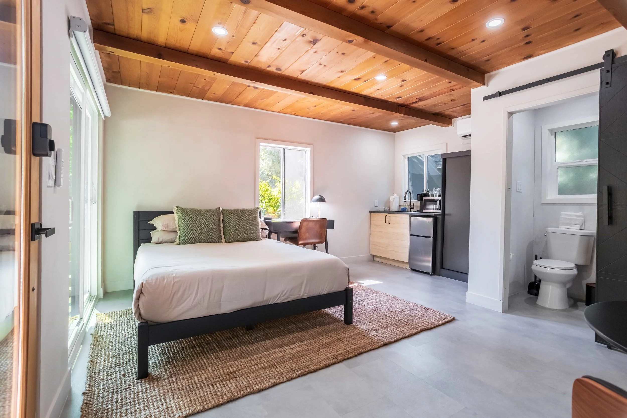 Welcome to "Cabin 8" of The PineTree Hotel.

courtyard wellness Studio with kitchenette
queen bed
bistro dining table
coworking desk
private patio with 2 Adirondack chairs
large sliding door
sleeps 2