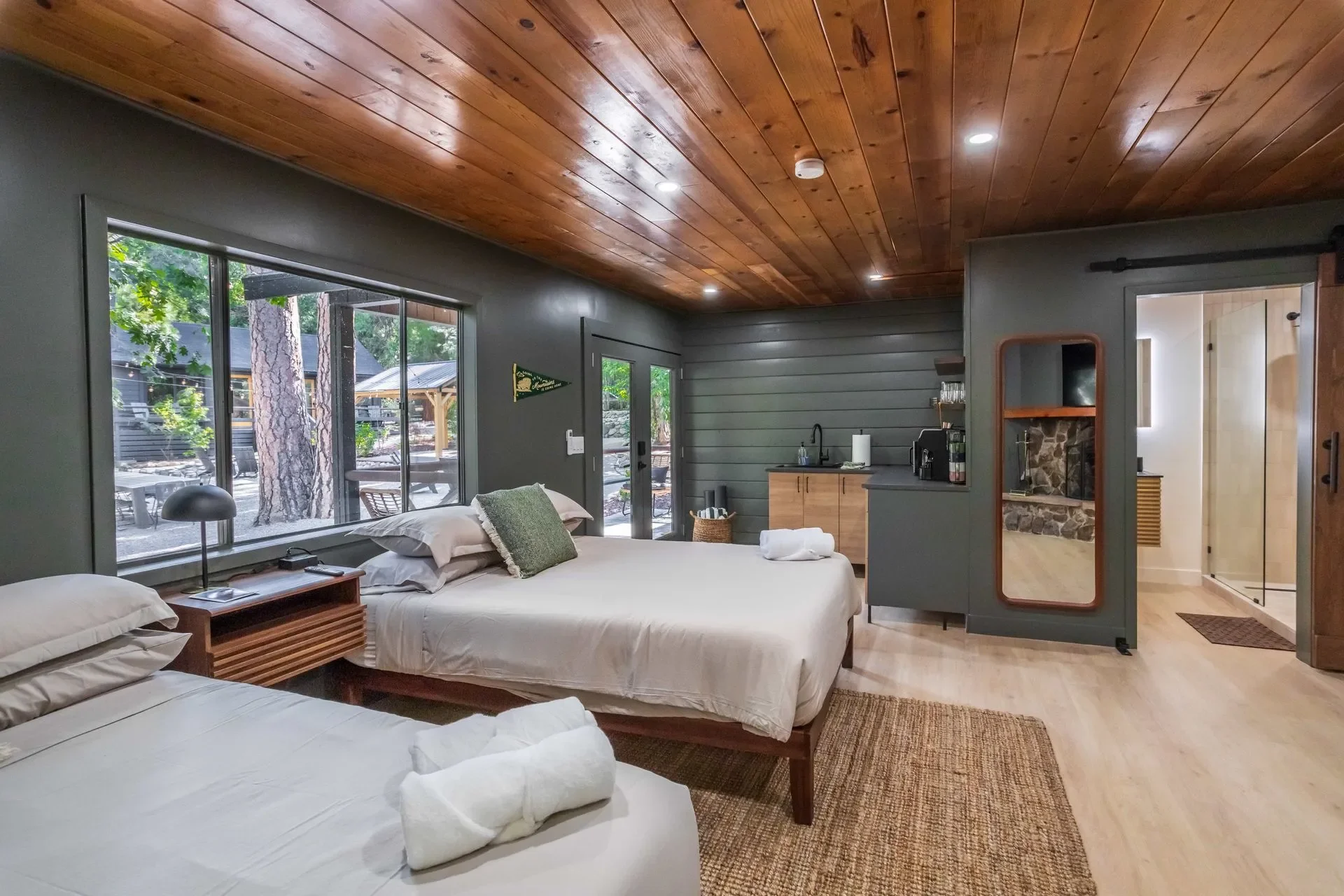 Welcome to "Cabin 9" of The Pinetree Hotel.

courtyard double queen cabin 
two queen beds
large stone fireplace
kitchenette with sink, microwave, coffee maker,
mini fridge + freezer.
sofa
private patio with 2 chairs
large tiled bathroom