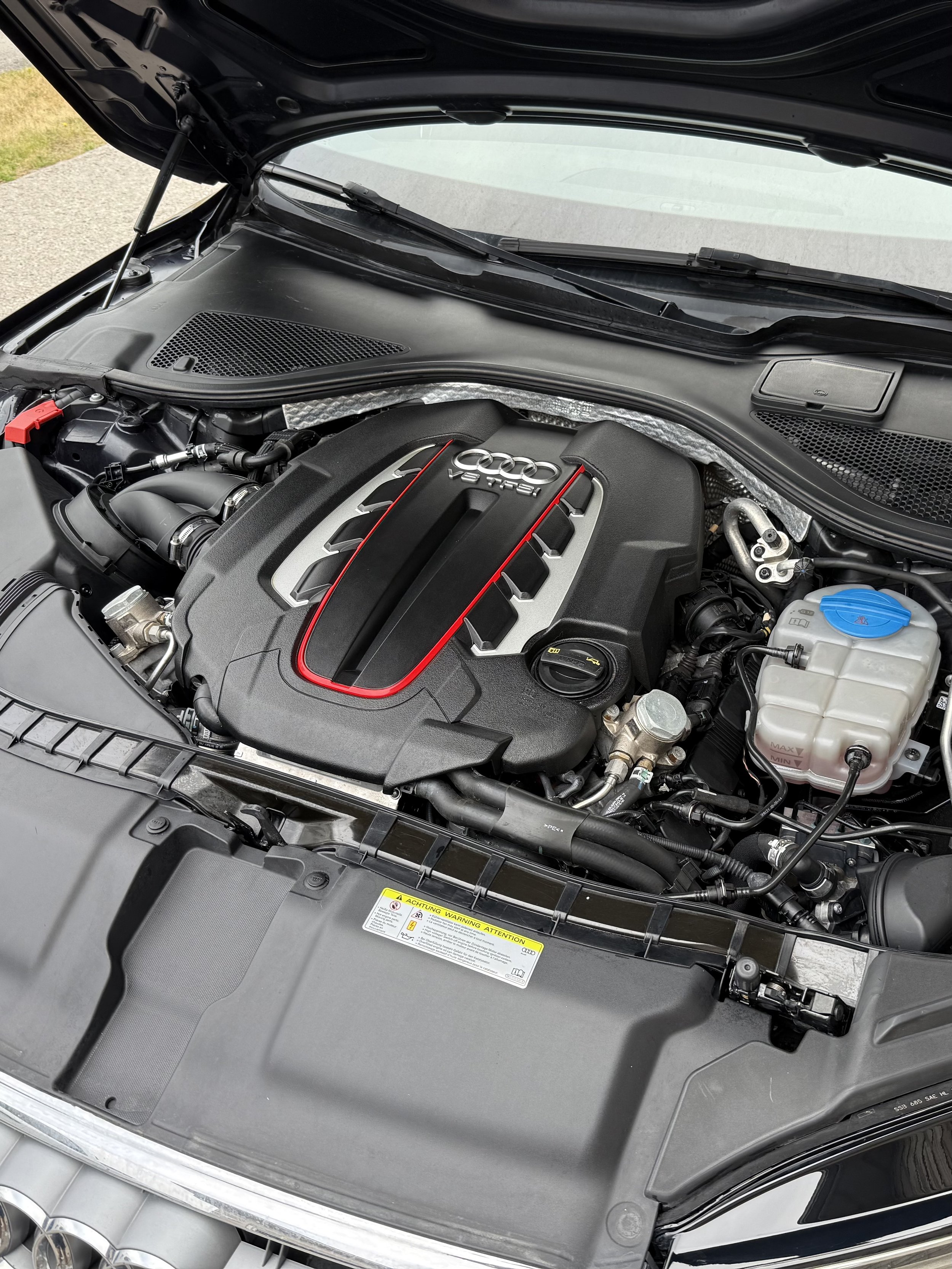 Engine bay of an Audi vehicle with a V8 TFSI engine.