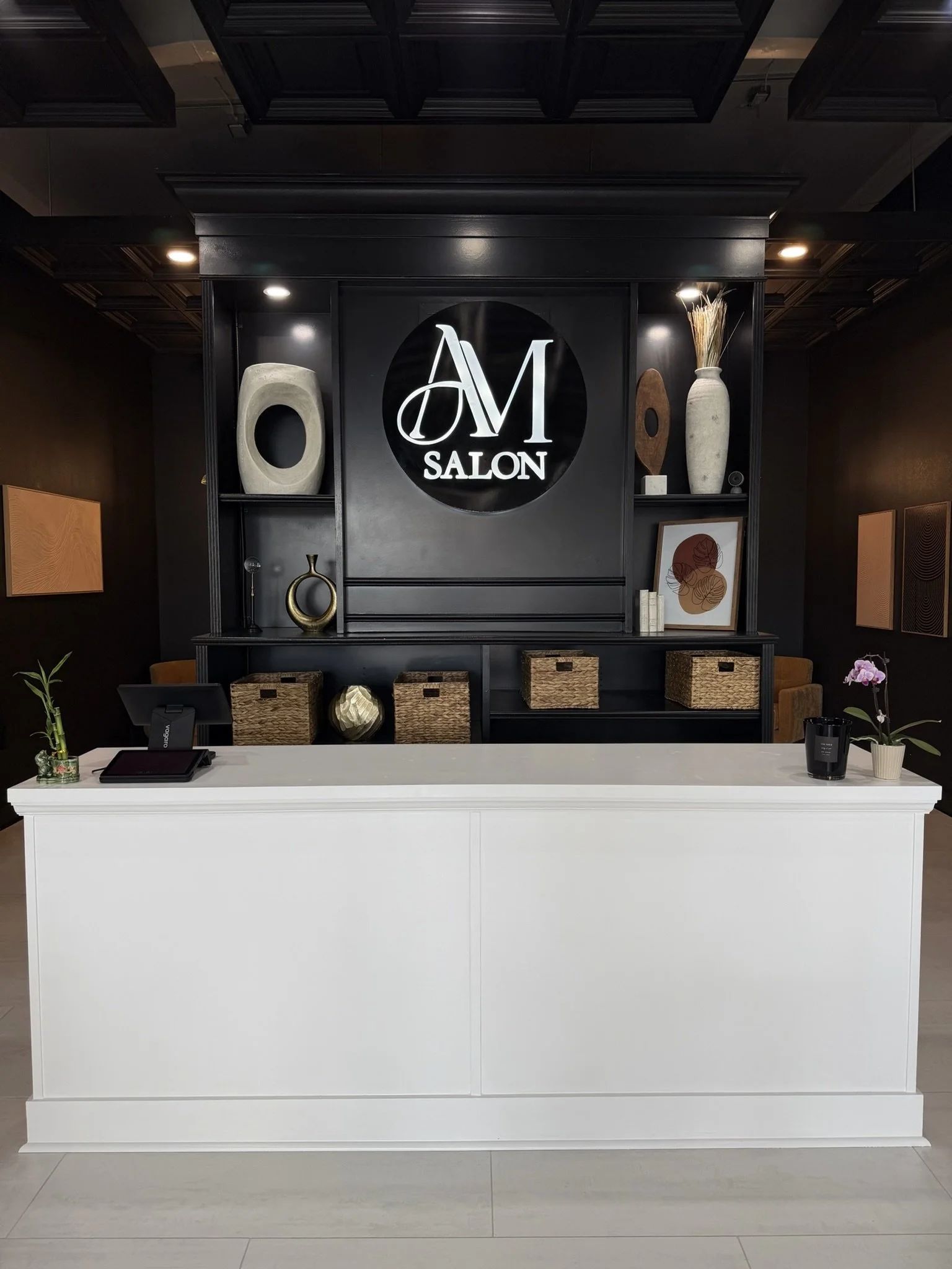We designed our front desk to feel clean, elevated, and welcoming from the moment you walk in. 

With thoughtfully styled décor and our signature branding at the center, it sets the tone for a polished, high-end salon experience.