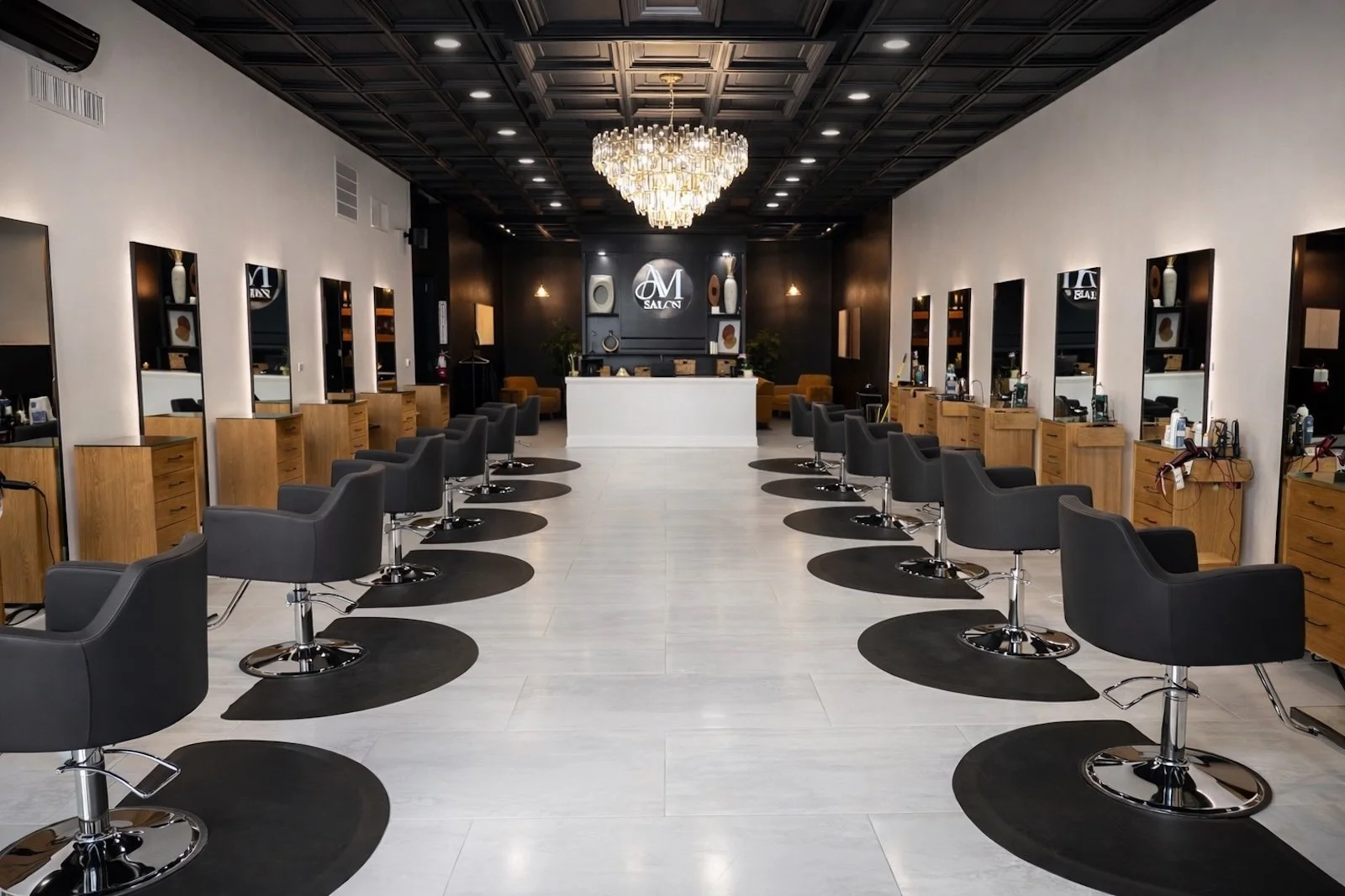 We designed our salon floor to feel open, elevated, and intentionally curated. With a clean, symmetrical layout, modern styling chairs, and a blend of warm and bold finishes, the space feels both professional and inviting. 

The statement lighting an