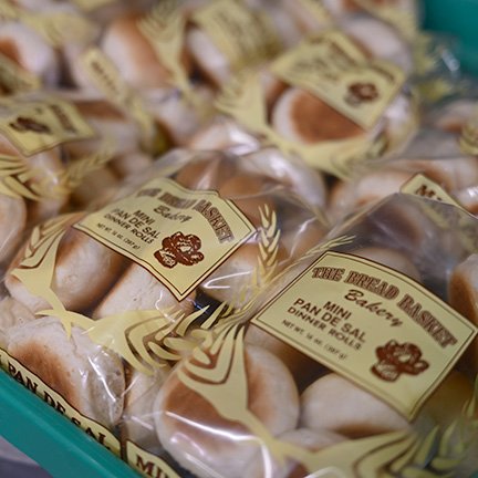 Packaged baked goods with a label reading 'The Original Bakery' and 'Pan Dulce Sal' in a blue container.