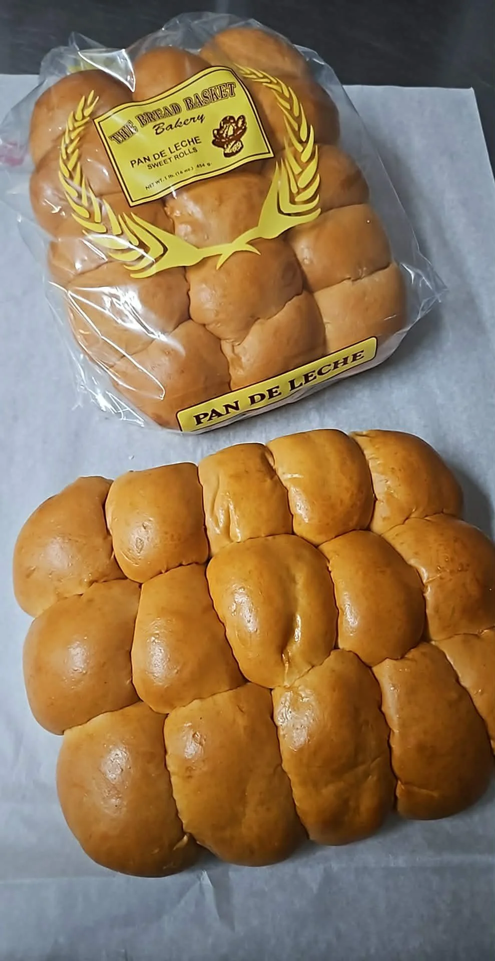 Bakery bread in packaging labeled 'The Bread Basket Bakery Pan de Leche Sweet Rolls' with a lemon graphic on the front.