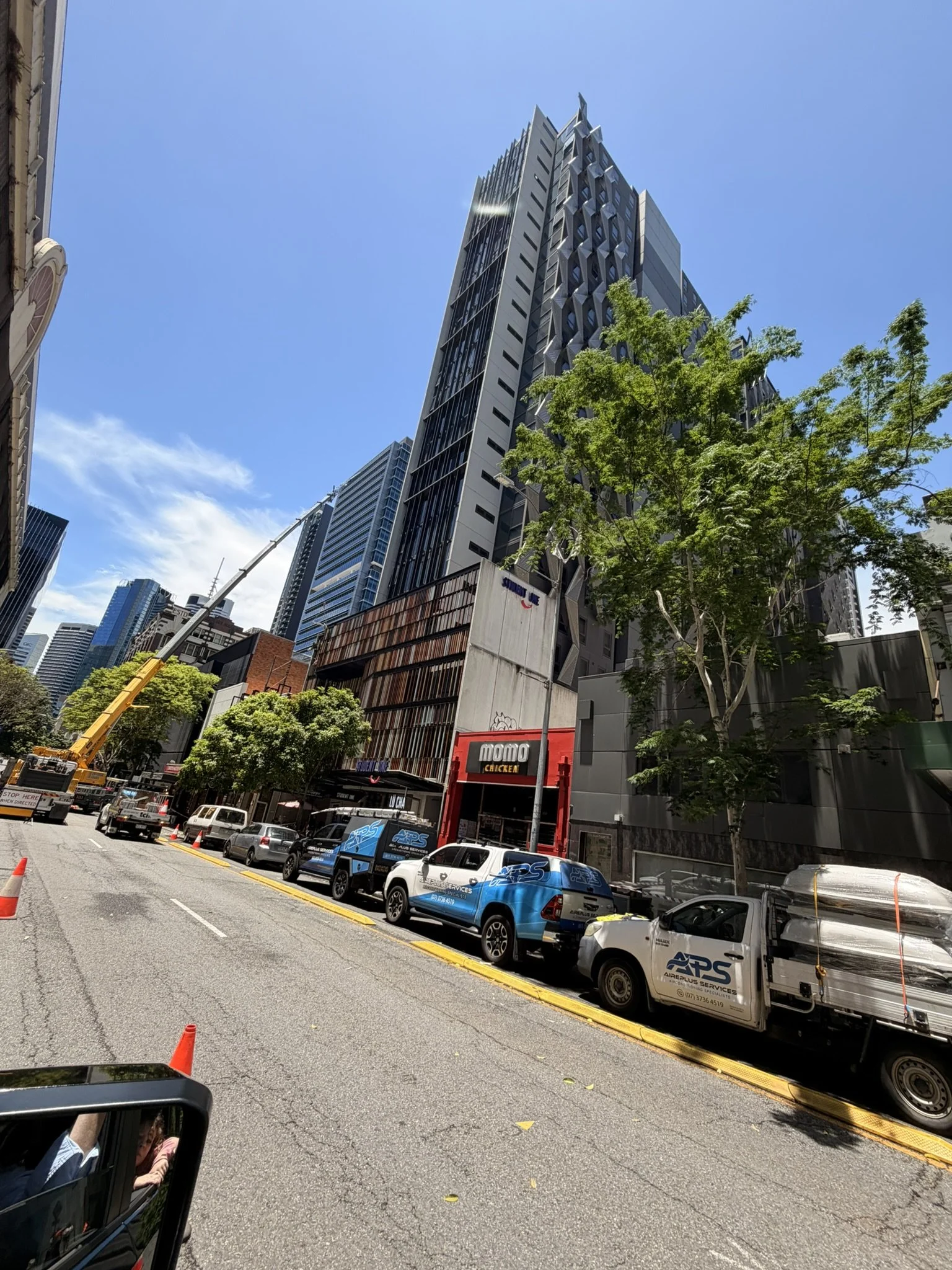 Crane set up on Albert Street for replacement of 9 rooftop package units and full rooftop duct upgrade across a commercial building in Brisbane CBD.
