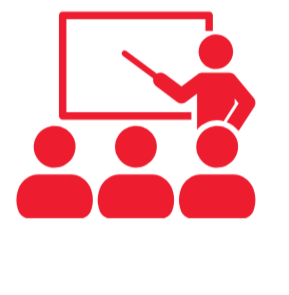 A teacher standing in front of a blackboard pointing at it, with three students seated facing the teacher.