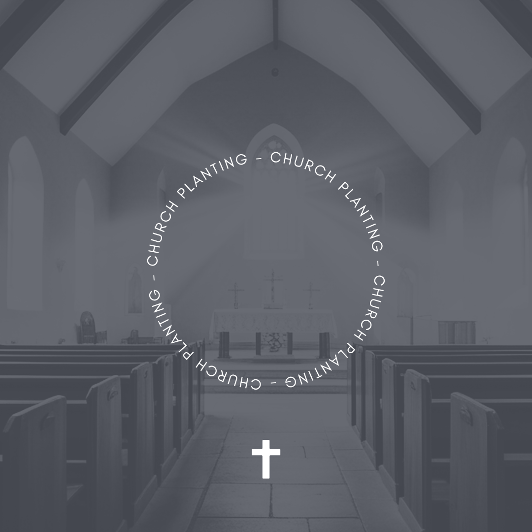 Interior of a church with an altar at the front, wooden pews, and arched windows.